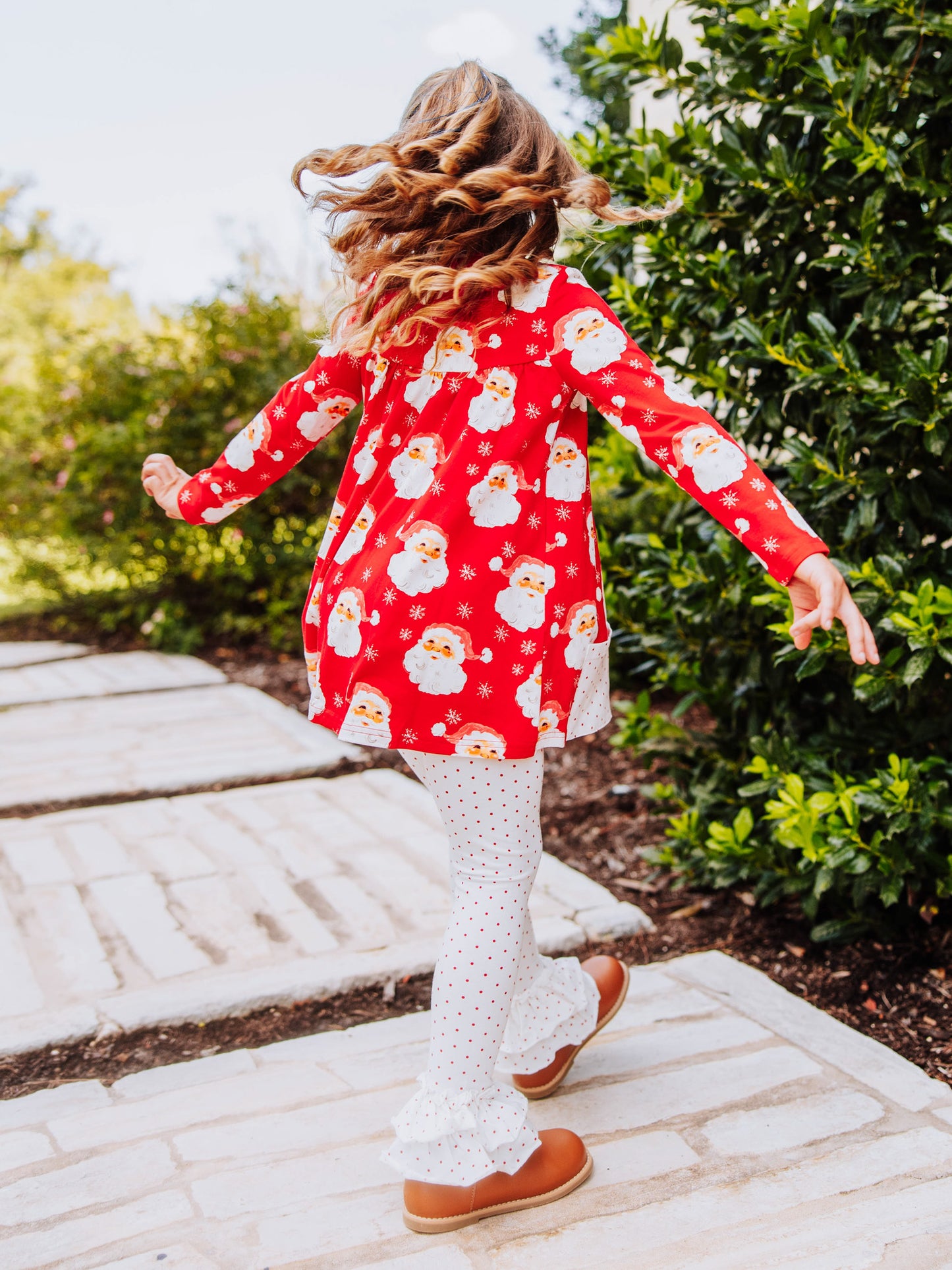 Girl wearing a jolly santa printed out to play set