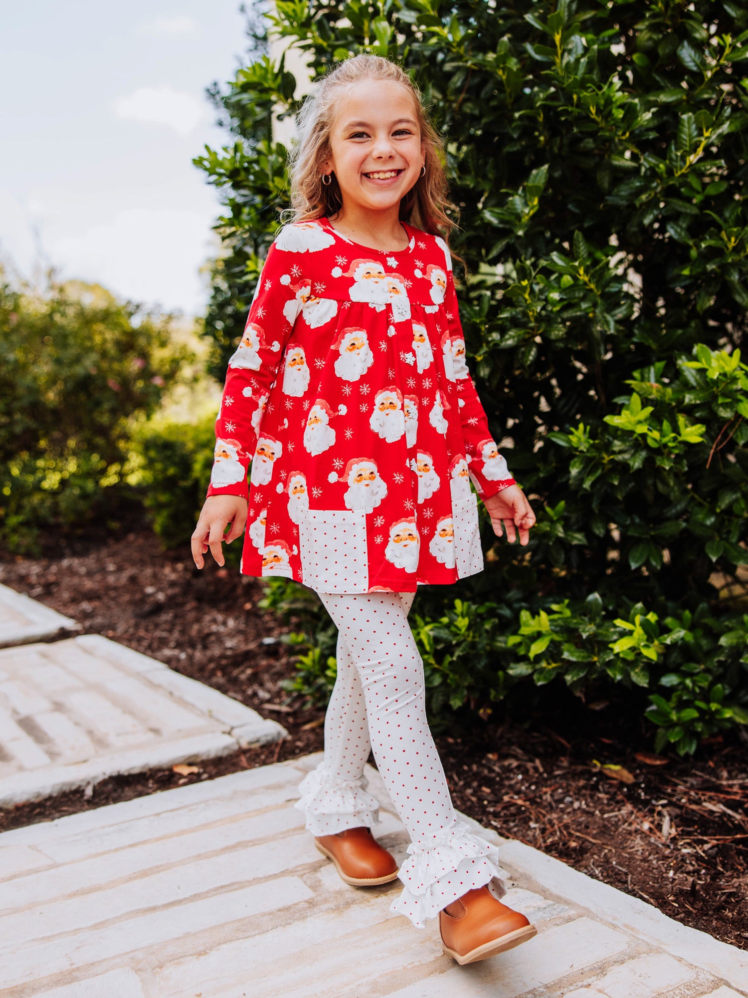 Girl wearing a jolly santa printed out to play set