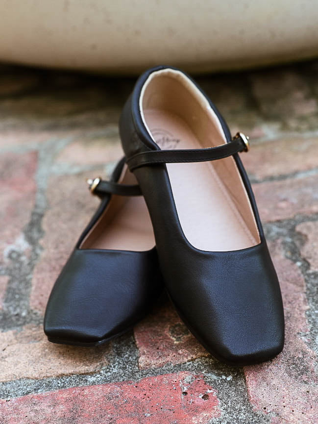Picture of black ballet mary janes with square toe and a clasp closure. 