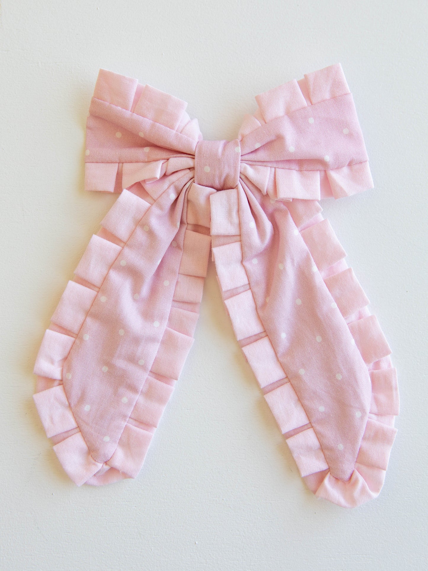 Add the perfect finishing touch to any outfit with our Pleated Bow! This classic girls’ hair bow features soft, textured pleats that create a timeless look for every occasion — from school days to special celebrations. Attached to a secure alligator clip, it stays perfectly in place through every twirl and playdate. Available in a variety of colors to match all her favorite SweetHoney styles, this bow is both stylish and sweet — a must-have accessory for every little girl’s wardrobe.