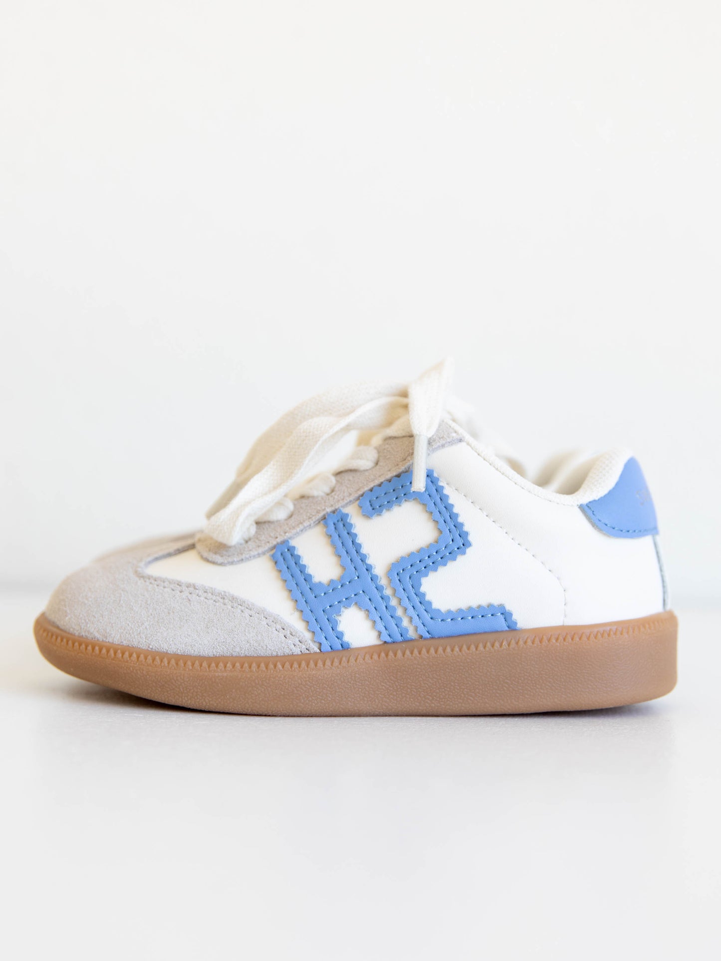 Fresh, fun, and full of SweetHoney style — our Signature Sneakers in dusty blue and white are the perfect mix of comfort and charm! Featuring our bold “SH” SweetHoney logo, soft suede accents, and durable gum soles, these boutique kids’ sneakers are designed for everyday adventures. Whether paired with twirl dresses or playtime outfits, they’re the ultimate blend of fashion and function for little trendsetters on the go.