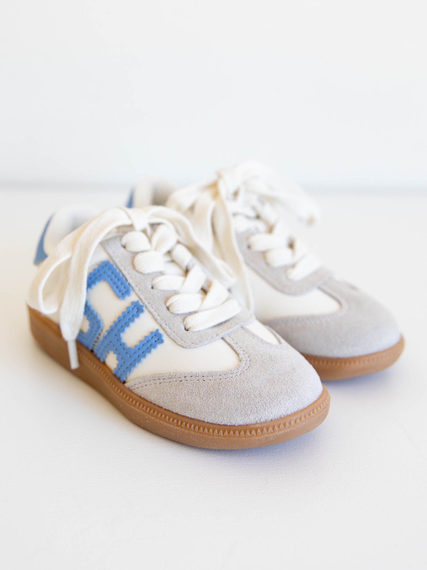 Fresh, fun, and full of SweetHoney style — our Signature Sneakers in dusty blue and white are the perfect mix of comfort and charm! Featuring our bold “SH” SweetHoney logo, soft suede accents, and durable gum soles, these boutique kids’ sneakers are designed for everyday adventures. Whether paired with twirl dresses or playtime outfits, they’re the ultimate blend of fashion and function for little trendsetters on the go.