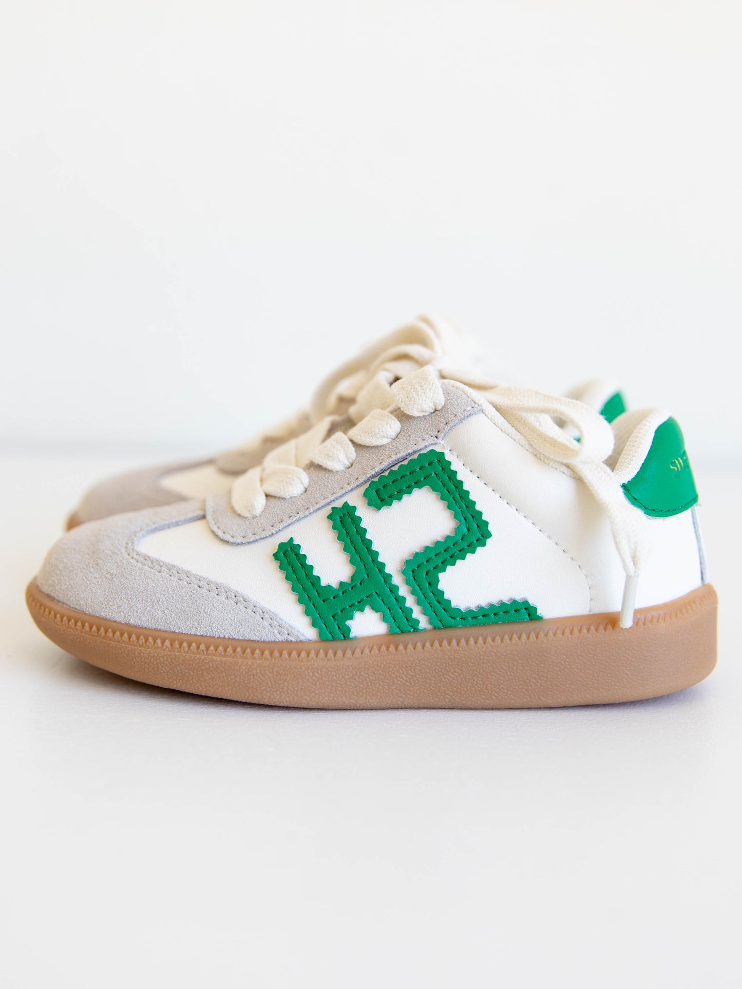 Fresh, fun, and full of SweetHoney style — our Signature Sneakers in green and white are the perfect mix of comfort and charm! Featuring our bold “SH” SweetHoney logo, soft suede accents, and durable gum soles, these boutique kids’ sneakers are designed for everyday adventures. Whether paired with twirl dresses or playtime outfits, they’re the ultimate blend of fashion and function for little trendsetters on the go.