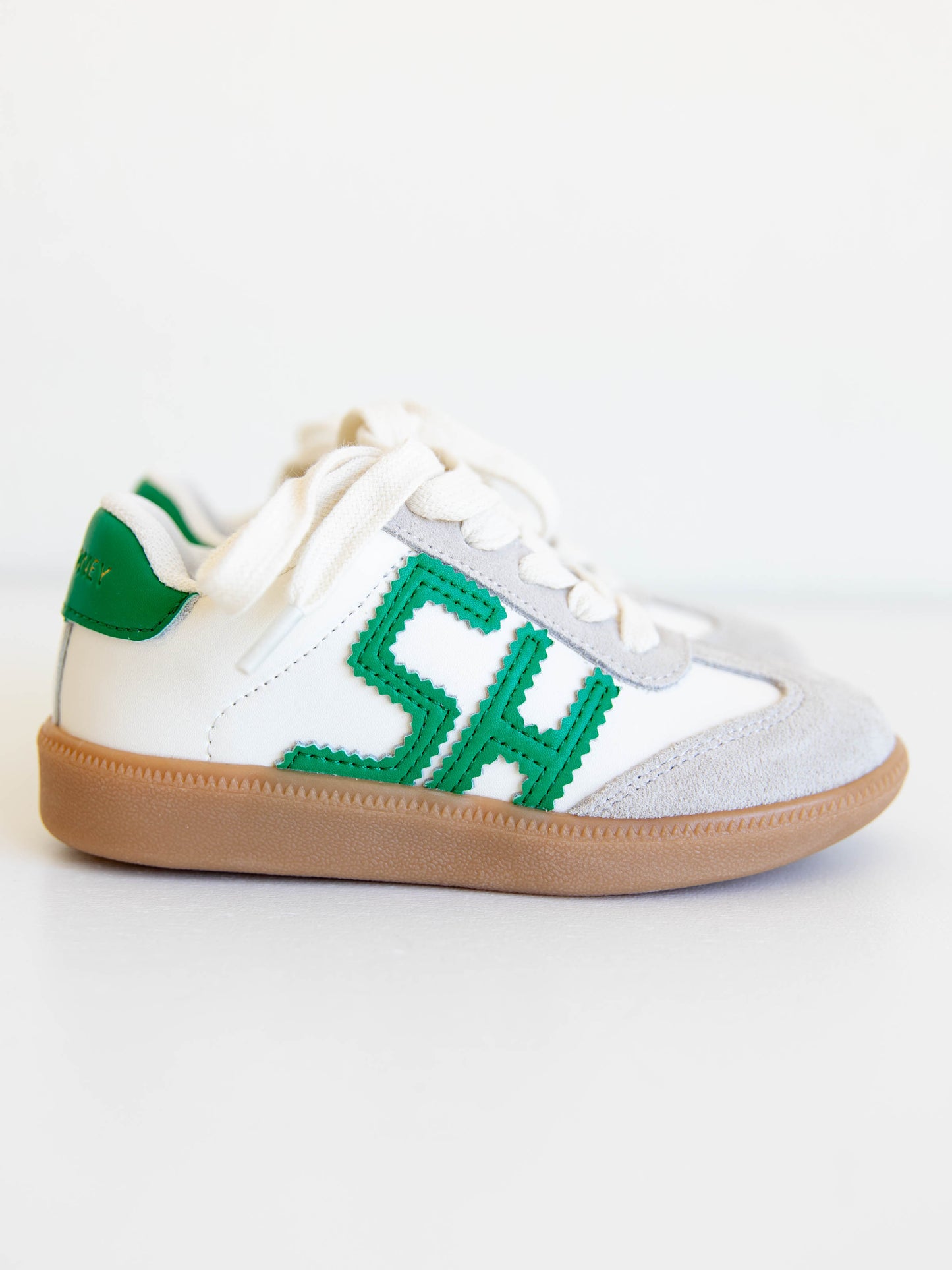 Fresh, fun, and full of SweetHoney style — our Signature Sneakers in green and white are the perfect mix of comfort and charm! Featuring our bold “SH” SweetHoney logo, soft suede accents, and durable gum soles, these boutique kids’ sneakers are designed for everyday adventures. Whether paired with twirl dresses or playtime outfits, they’re the ultimate blend of fashion and function for little trendsetters on the go.