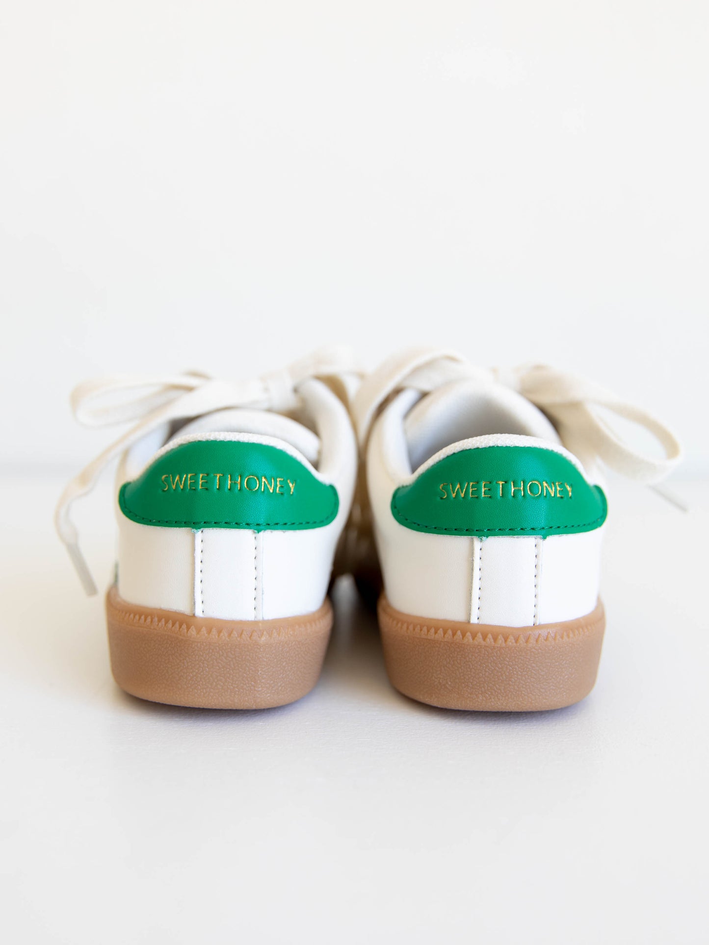 Fresh, fun, and full of SweetHoney style — our Signature Sneakers in green and white are the perfect mix of comfort and charm! Featuring our bold “SH” SweetHoney logo, soft suede accents, and durable gum soles, these boutique kids’ sneakers are designed for everyday adventures. Whether paired with twirl dresses or playtime outfits, they’re the ultimate blend of fashion and function for little trendsetters on the go.