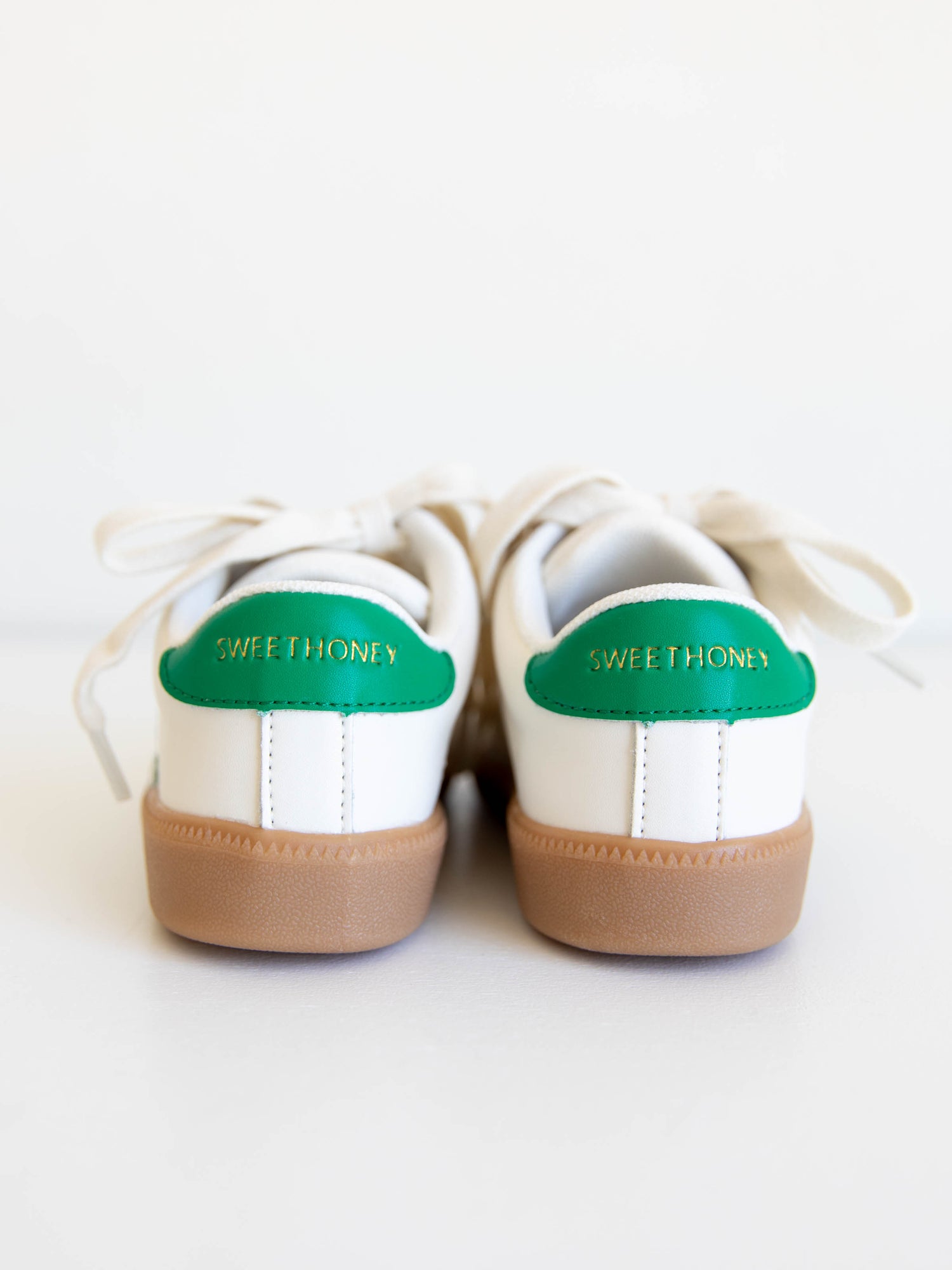 Fresh, fun, and full of SweetHoney style — our Signature Sneakers in green and white are the perfect mix of comfort and charm! Featuring our bold “SH” SweetHoney logo, soft suede accents, and durable gum soles, these boutique kids’ sneakers are designed for everyday adventures. Whether paired with twirl dresses or playtime outfits, they’re the ultimate blend of fashion and function for little trendsetters on the go.