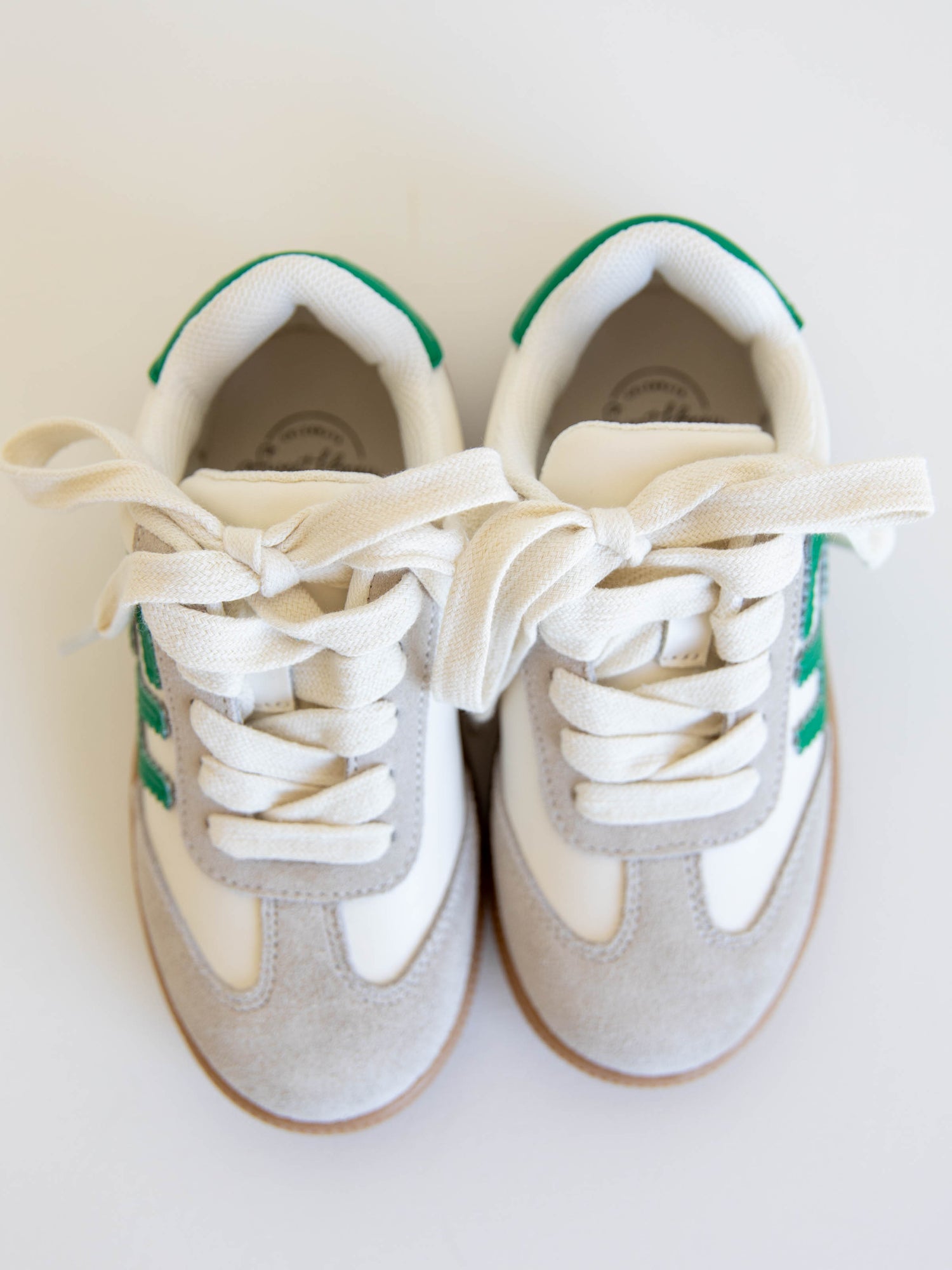 Fresh, fun, and full of SweetHoney style — our Signature Sneakers in green and white are the perfect mix of comfort and charm! Featuring our bold “SH” SweetHoney logo, soft suede accents, and durable gum soles, these boutique kids’ sneakers are designed for everyday adventures. Whether paired with twirl dresses or playtime outfits, they’re the ultimate blend of fashion and function for little trendsetters on the go.