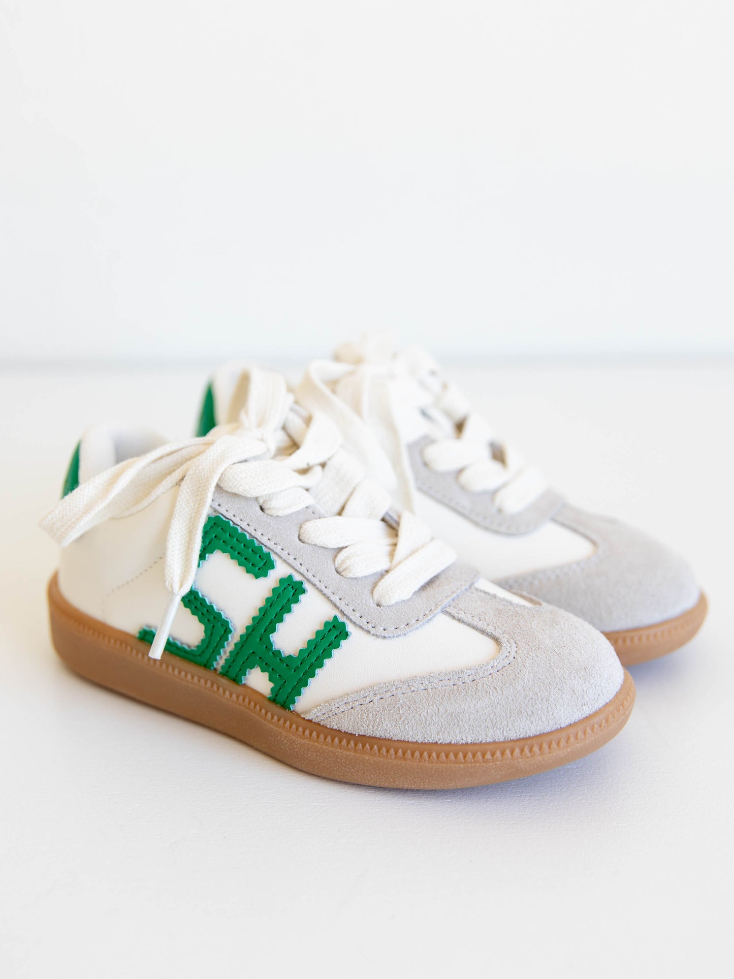 Fresh, fun, and full of SweetHoney style — our Signature Sneakers in green and white are the perfect mix of comfort and charm! Featuring our bold “SH” SweetHoney logo, soft suede accents, and durable gum soles, these boutique kids’ sneakers are designed for everyday adventures. Whether paired with twirl dresses or playtime outfits, they’re the ultimate blend of fashion and function for little trendsetters on the go.
