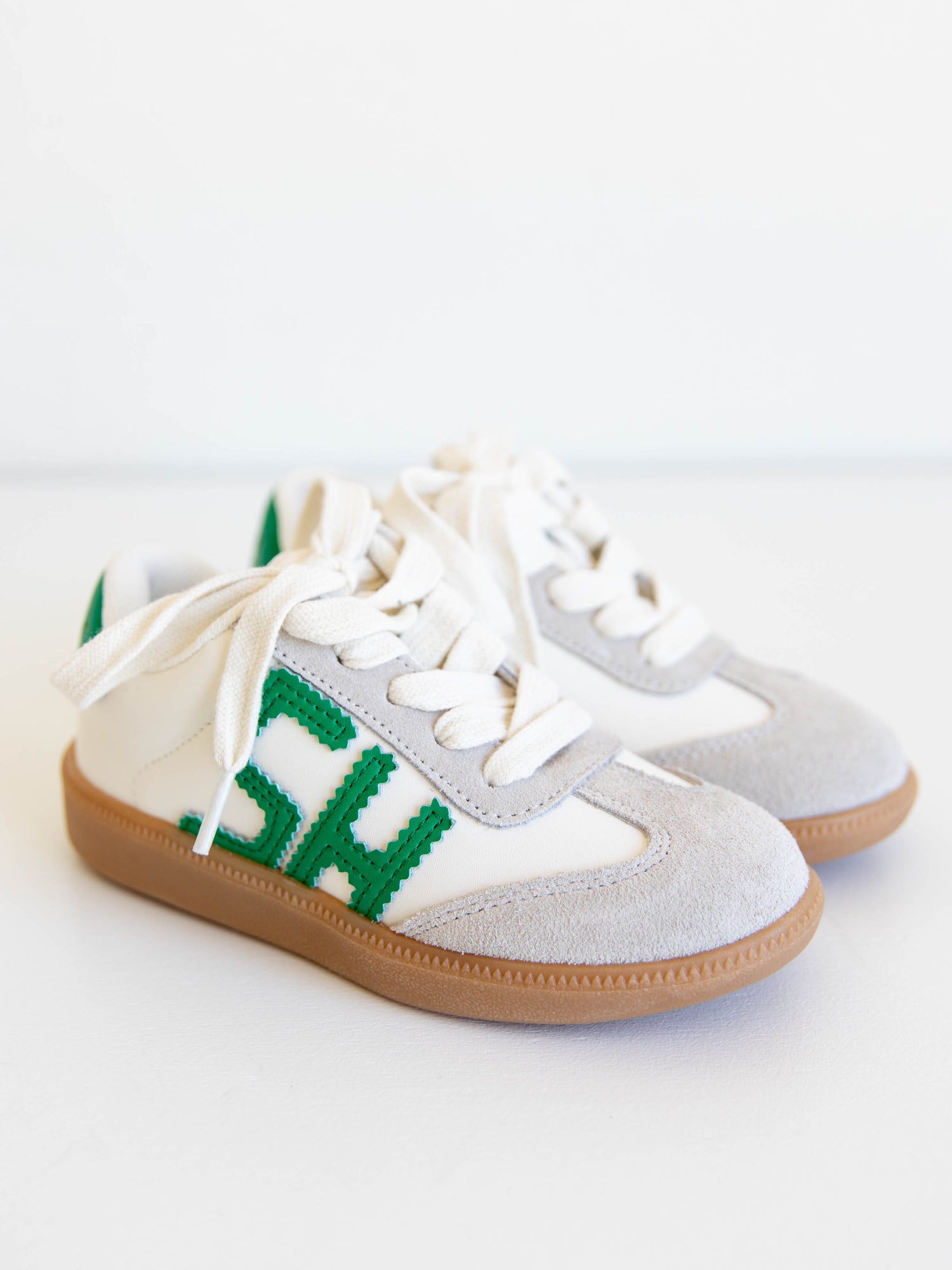 Fresh, fun, and full of SweetHoney style — our Signature Sneakers in green and white are the perfect mix of comfort and charm! Featuring our bold “SH” SweetHoney logo, soft suede accents, and durable gum soles, these boutique kids’ sneakers are designed for everyday adventures. Whether paired with twirl dresses or playtime outfits, they’re the ultimate blend of fashion and function for little trendsetters on the go.