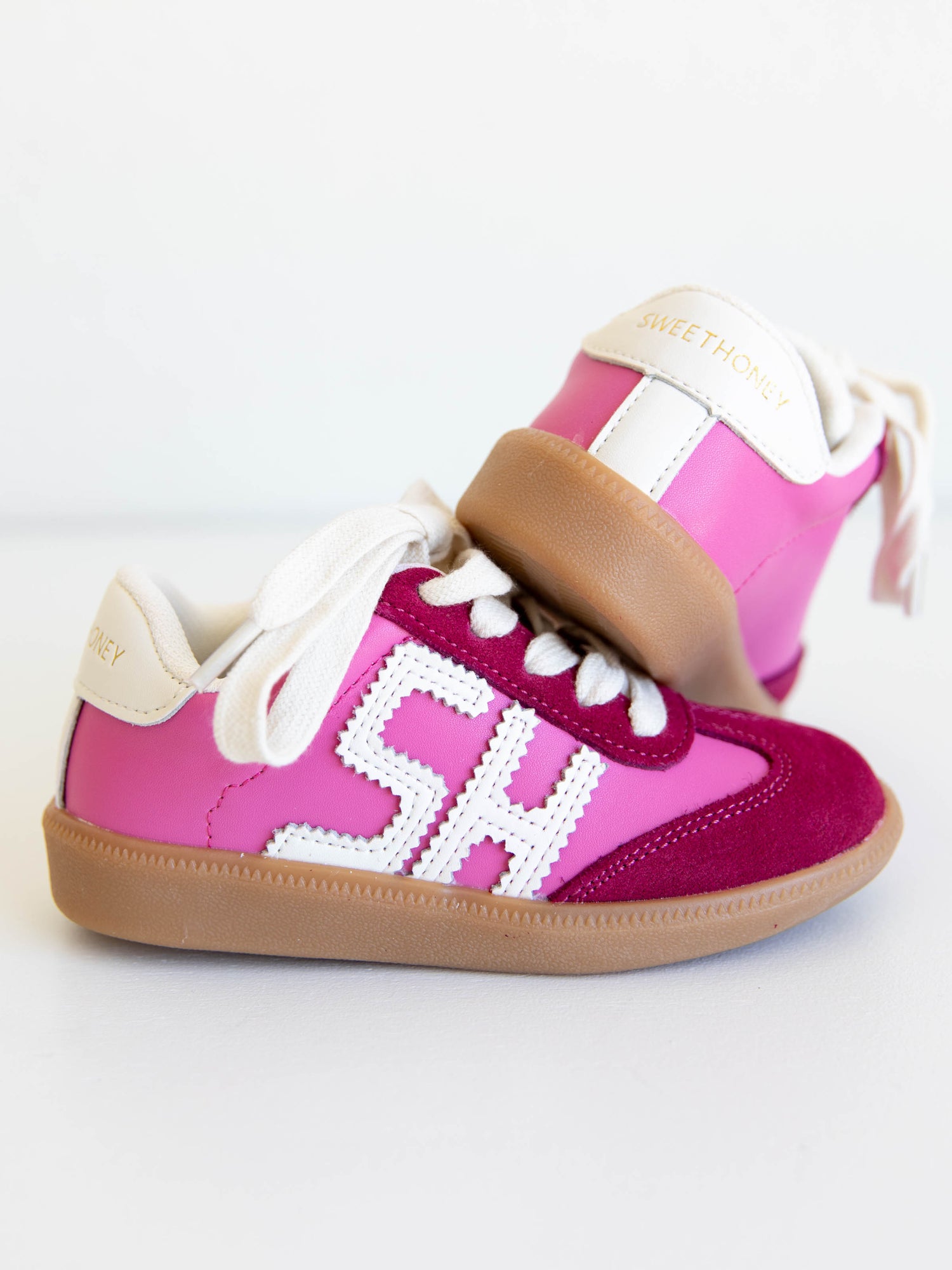 Step into style with our SweetHoney Signature Sneakers! Designed for comfort and play, these adorable girls’ sneakers feature a fun mix of pink and magenta tones with our signature “SH” SweetHoney logo for a bold, playful touch. Crafted with soft materials, sturdy soles, and easy lace-up styling, they’re perfect for school days, adventures, and everyday wear. Combining fashion and function, these sneakers are a must-have for every little trendsetter!
