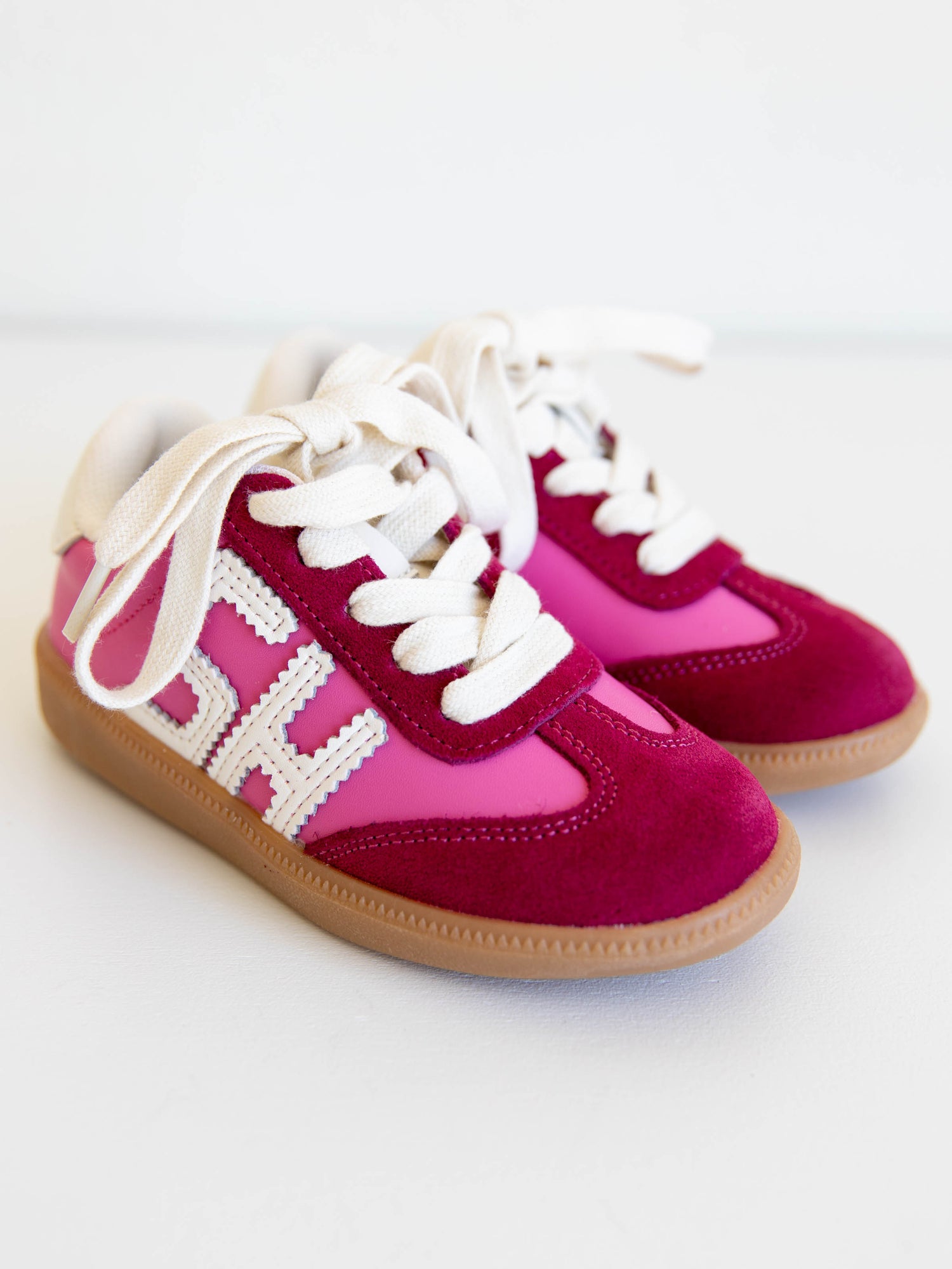 Step into style with our SweetHoney Signature Sneakers! Designed for comfort and play, these adorable girls’ sneakers feature a fun mix of pink and red tones with our signature “SH” SweetHoney logo for a bold, playful touch. Crafted with soft materials, sturdy soles, and easy lace-up styling, they’re perfect for school days, adventures, and everyday wear. Combining fashion and function, these sneakers are a must-have for every little trendsetter!