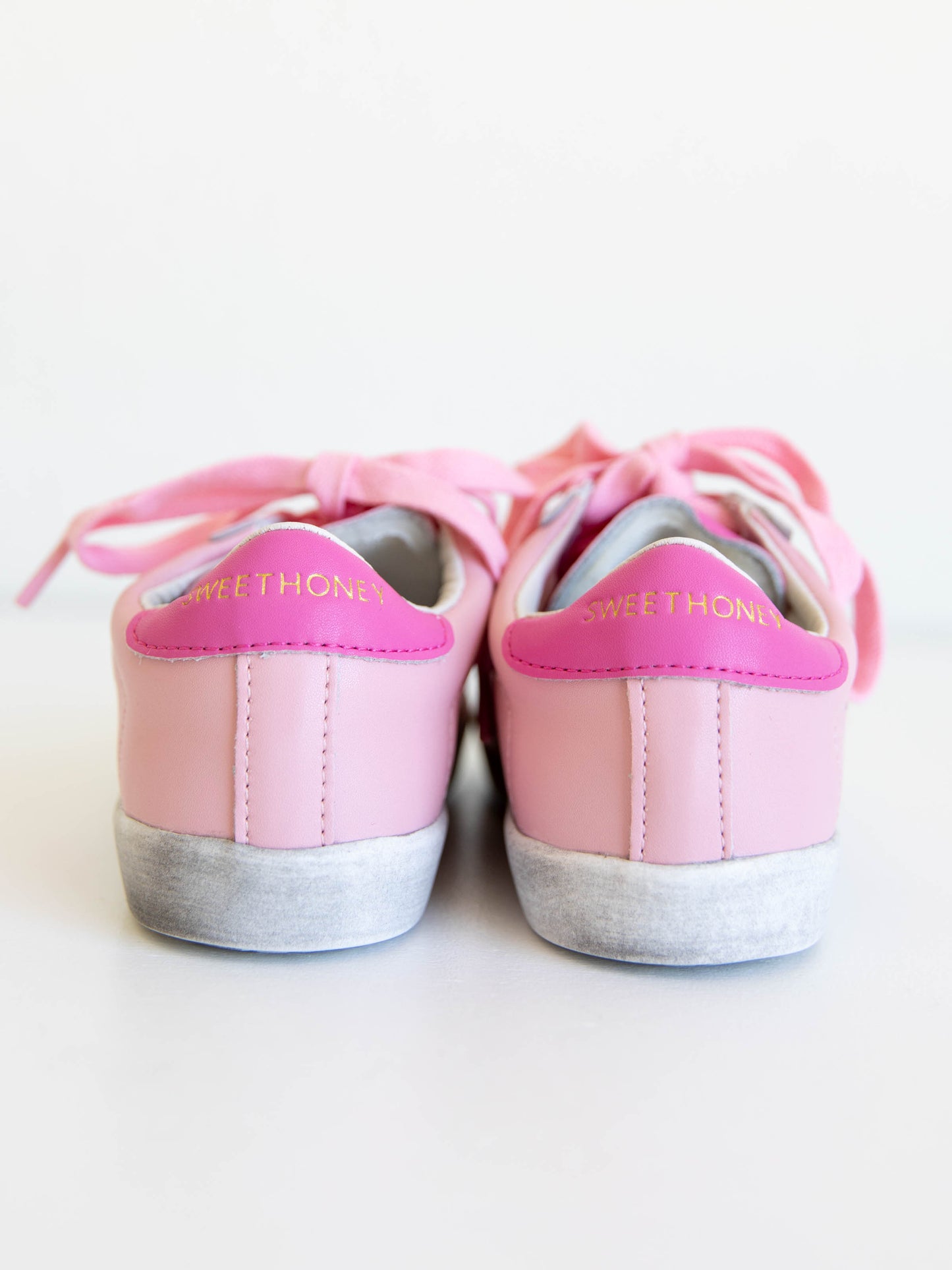 Step into sparkle and style with our SweetHoney Star Sneakers in pretty shades of pink! These boutique kids’ sneakers feature a glittery star detail, soft suede accents, and comfy rubber soles — perfect for playdates, school days, or twirling through the weekend. Designed for both comfort and cuteness, these girls pink sneakers add a touch of magic to every outfit while keeping little feet supported all day long.