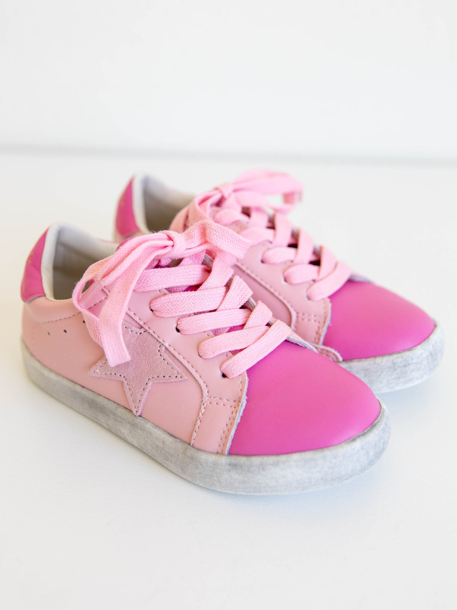 Step into sparkle and style with our SweetHoney Star Sneakers in pretty shades of pink! These boutique kids’ sneakers feature a glittery star detail, soft suede accents, and comfy rubber soles — perfect for playdates, school days, or twirling through the weekend. Designed for both comfort and cuteness, these girls pink sneakers add a touch of magic to every outfit while keeping little feet supported all day long.
