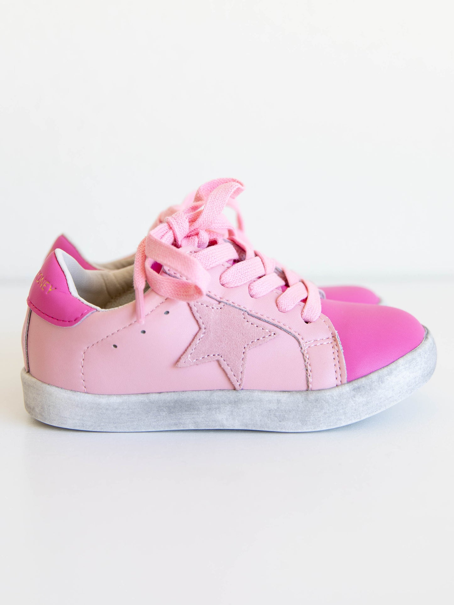 Step into sparkle and style with our SweetHoney Star Sneakers in pretty shades of pink! These boutique kids’ sneakers feature a glittery star detail, soft suede accents, and comfy rubber soles — perfect for playdates, school days, or twirling through the weekend. Designed for both comfort and cuteness, these girls pink sneakers add a touch of magic to every outfit while keeping little feet supported all day long.