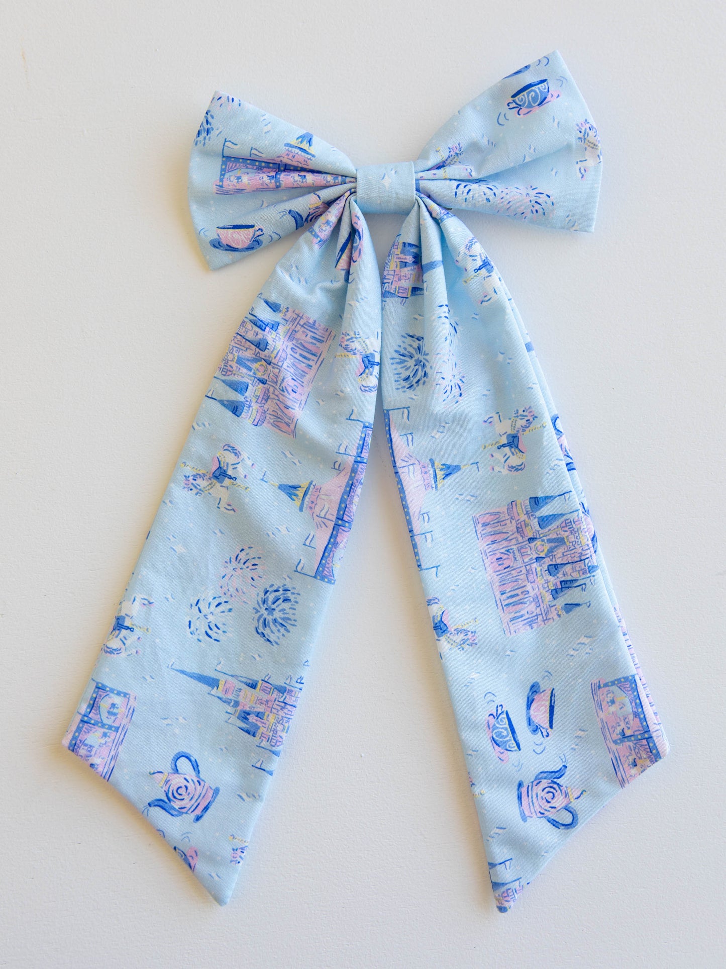 Add a touch of fairytale sparkle to any outfit with our Most Magical Long Tail Bow! This enchanting hair accessory features our signature Most Magical print — filled with dreamy castles, teacups, and fireworks in soft pastel hues. Made from smooth, lightweight fabric with flowing tails, it ties perfectly for picture days, park days, or magical adventures. A must-have finishing touch for your little princess!