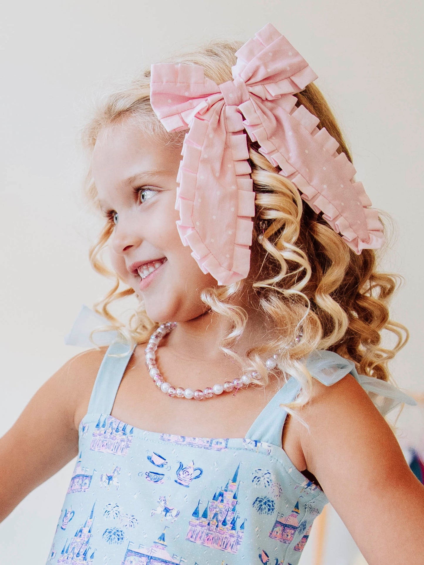 Add the perfect finishing touch to any outfit with our Pleated Bow! This classic girls’ hair bow features soft, textured pleats that create a timeless look for every occasion — from school days to special celebrations. Attached to a secure alligator clip, it stays perfectly in place through every twirl and playdate. Available in a variety of colors to match all her favorite SweetHoney styles, this bow is both stylish and sweet — a must-have accessory for every little girl’s wardrobe.