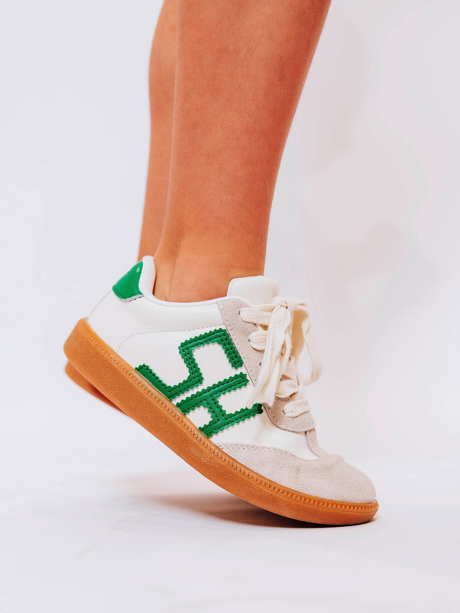 Fresh, fun, and full of SweetHoney style — our Signature Sneakers in green and white are the perfect mix of comfort and charm! Featuring our bold “SH” SweetHoney logo, soft suede accents, and durable gum soles, these boutique kids’ sneakers are designed for everyday adventures. Whether paired with twirl dresses or playtime outfits, they’re the ultimate blend of fashion and function for little trendsetters on the go.