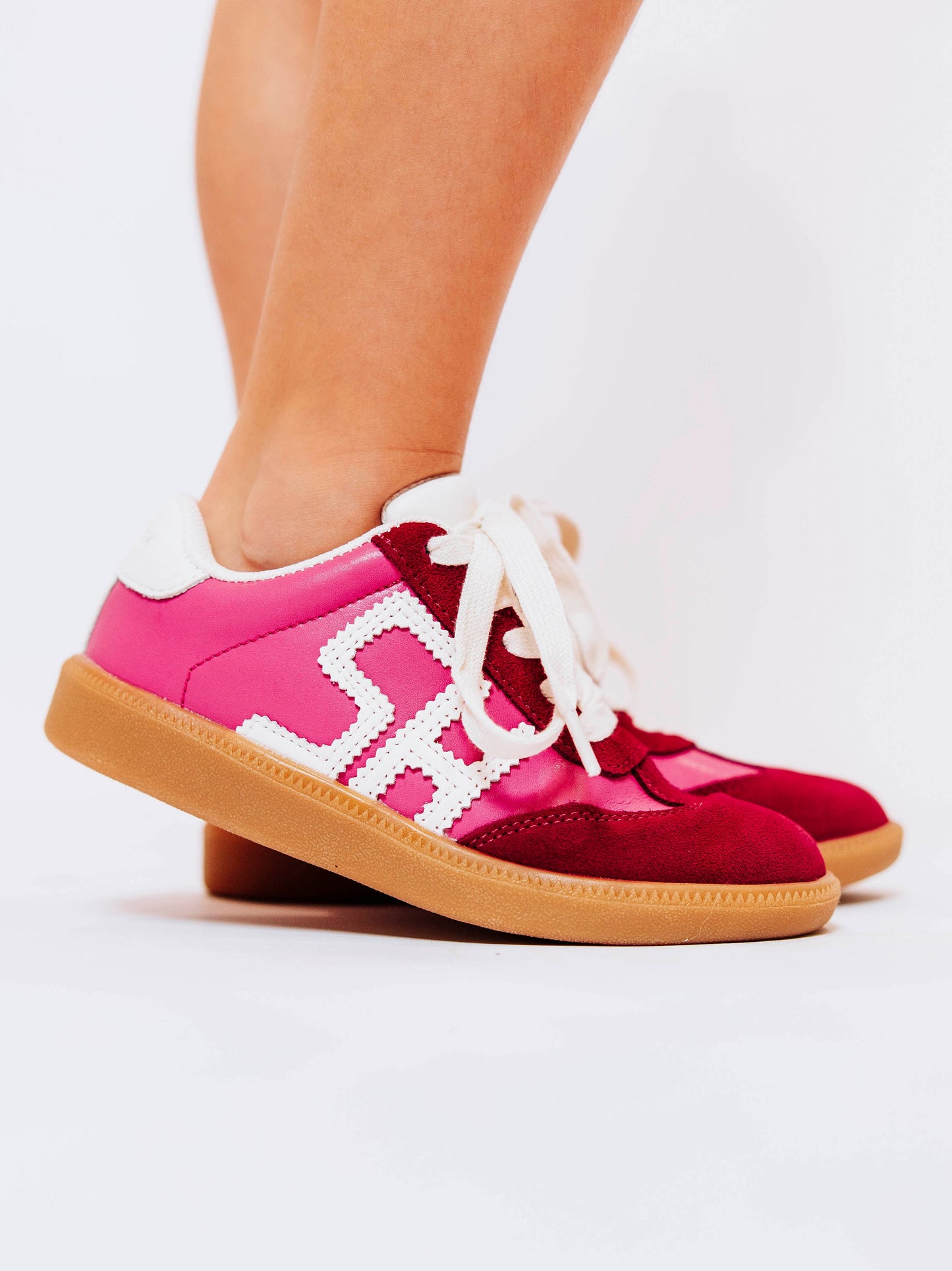Step into style with our SweetHoney Signature Sneakers! Designed for comfort and play, these adorable girls’ sneakers feature a fun mix of pink and red tones with our signature “SH” SweetHoney logo for a bold, playful touch. Crafted with soft materials, sturdy soles, and easy lace-up styling, they’re perfect for school days, adventures, and everyday wear. Combining fashion and function, these sneakers are a must-have for every little trendsetter!