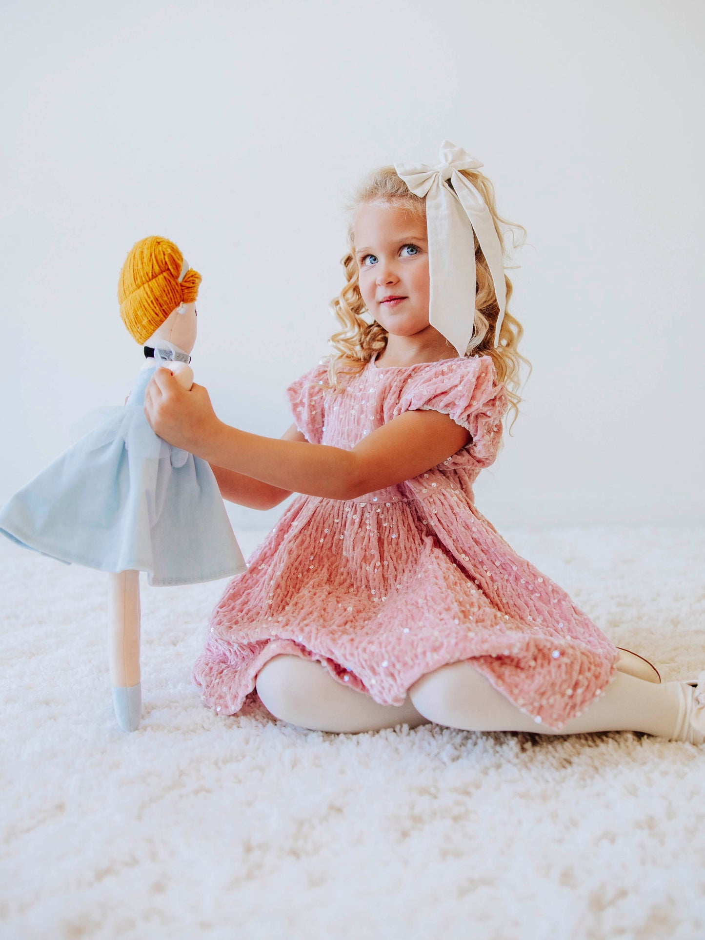 Make every moment shine in our Girls’ Sequin Sparkle Dress, designed for holiday parties, special occasions, and picture-perfect moments. Crafted from 100% polyester, this dress features a soft velvet-like texture that’s gentle on the skin and a smooth interior lining for all-day comfort. The fabric is covered in shimmering transparent sequins that catch the light beautifully, creating a dazzling effect with every twirl.