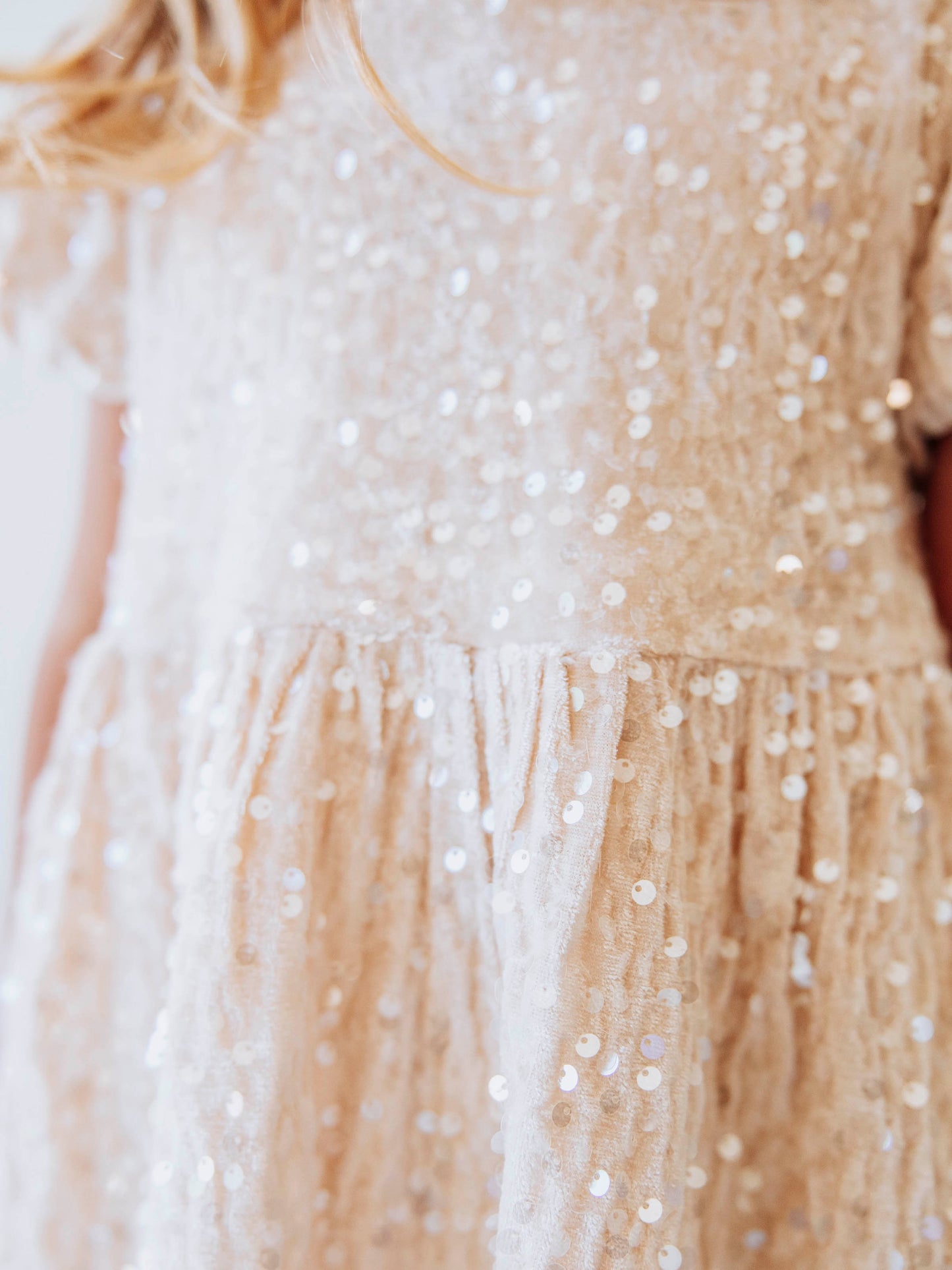 Make every moment shine in our Girls’ Sequin Sparkle Dress, designed for holiday parties, special occasions, and picture-perfect moments. Crafted from 100% polyester, this dress features a soft velvet-like texture that’s gentle on the skin and a smooth interior lining for all-day comfort. The fabric is covered in shimmering transparent sequins that catch the light beautifully, creating a dazzling effect with every twirl.