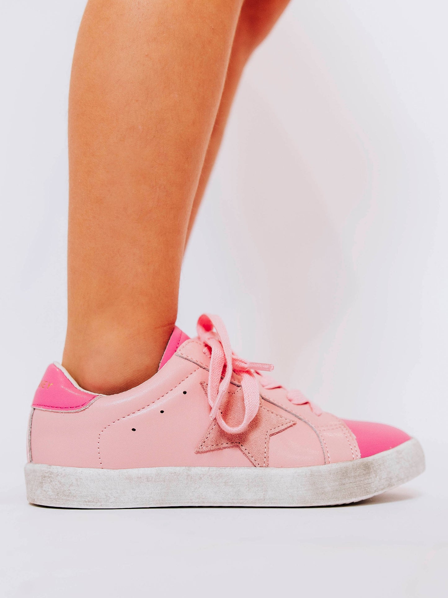 Step into sparkle and style with our SweetHoney Star Sneakers in pretty shades of pink! These boutique kids’ sneakers feature a glittery star detail, soft suede accents, and comfy rubber soles — perfect for playdates, school days, or twirling through the weekend. Designed for both comfort and cuteness, these girls pink sneakers add a touch of magic to every outfit while keeping little feet supported all day long.