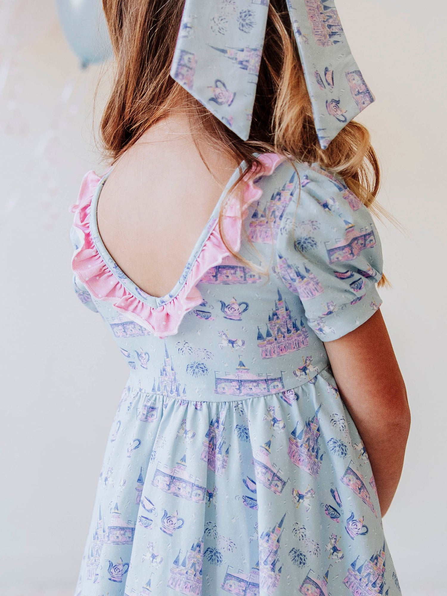 Bring a little fairytale charm to her day with our Most Magical Prim Dress! This enchanting dress features our exclusive Most Magical print — a whimsical pattern filled with castles, teacups, and dreamy pastel details. Designed with a sweet button-down front, short puff sleeves, and a full twirl skirt trimmed in pink polka dots, it’s perfect for playdates, park adventures, and magical memories.