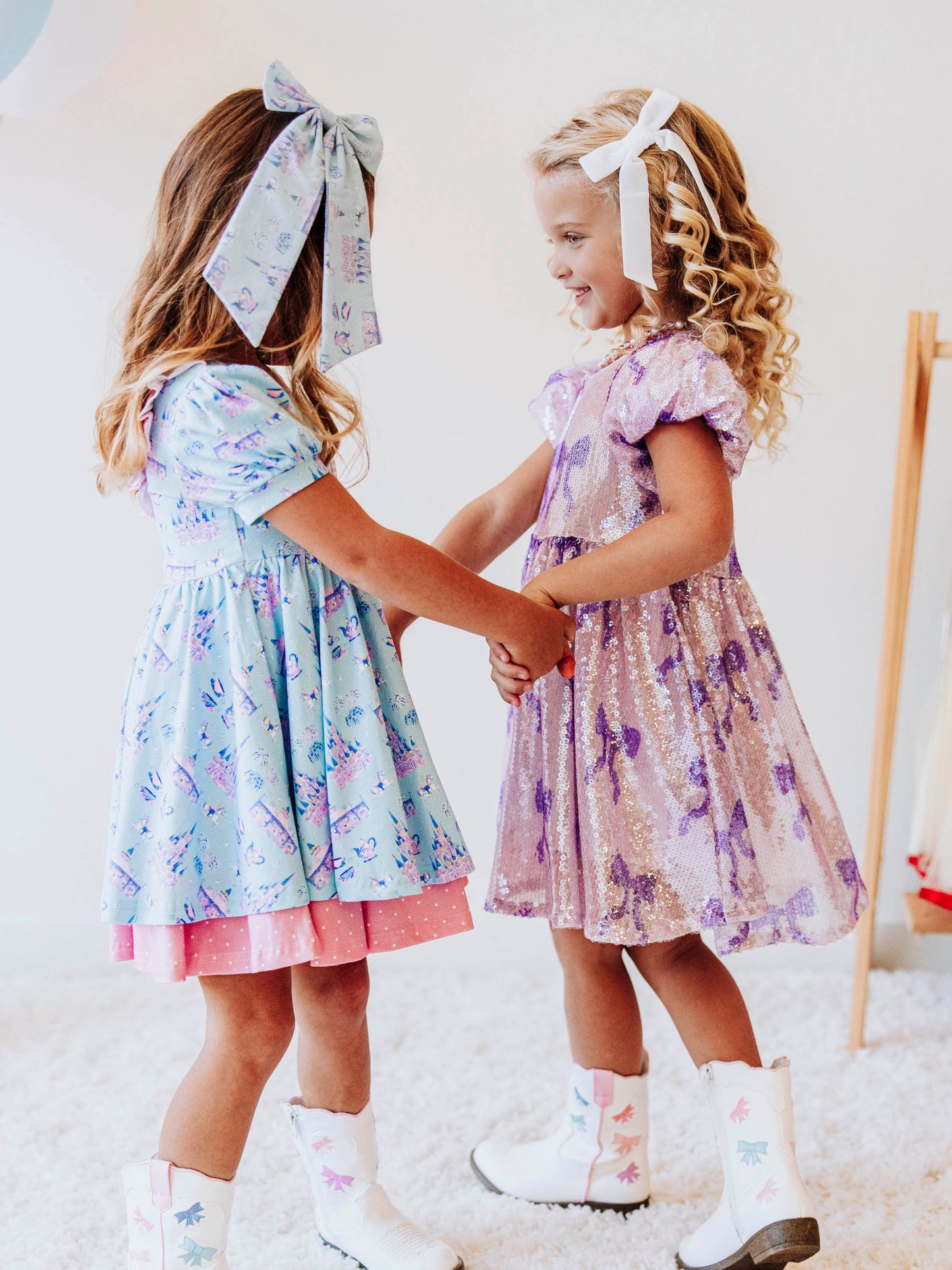 Bring a little fairytale charm to her day with our Most Magical Prim Dress! This enchanting dress features our exclusive Most Magical print — a whimsical pattern filled with castles, teacups, and dreamy pastel details. Designed with a sweet button-down front, short puff sleeves, and a full twirl skirt trimmed in pink polka dots, it’s perfect for playdates, park adventures, and magical memories.
