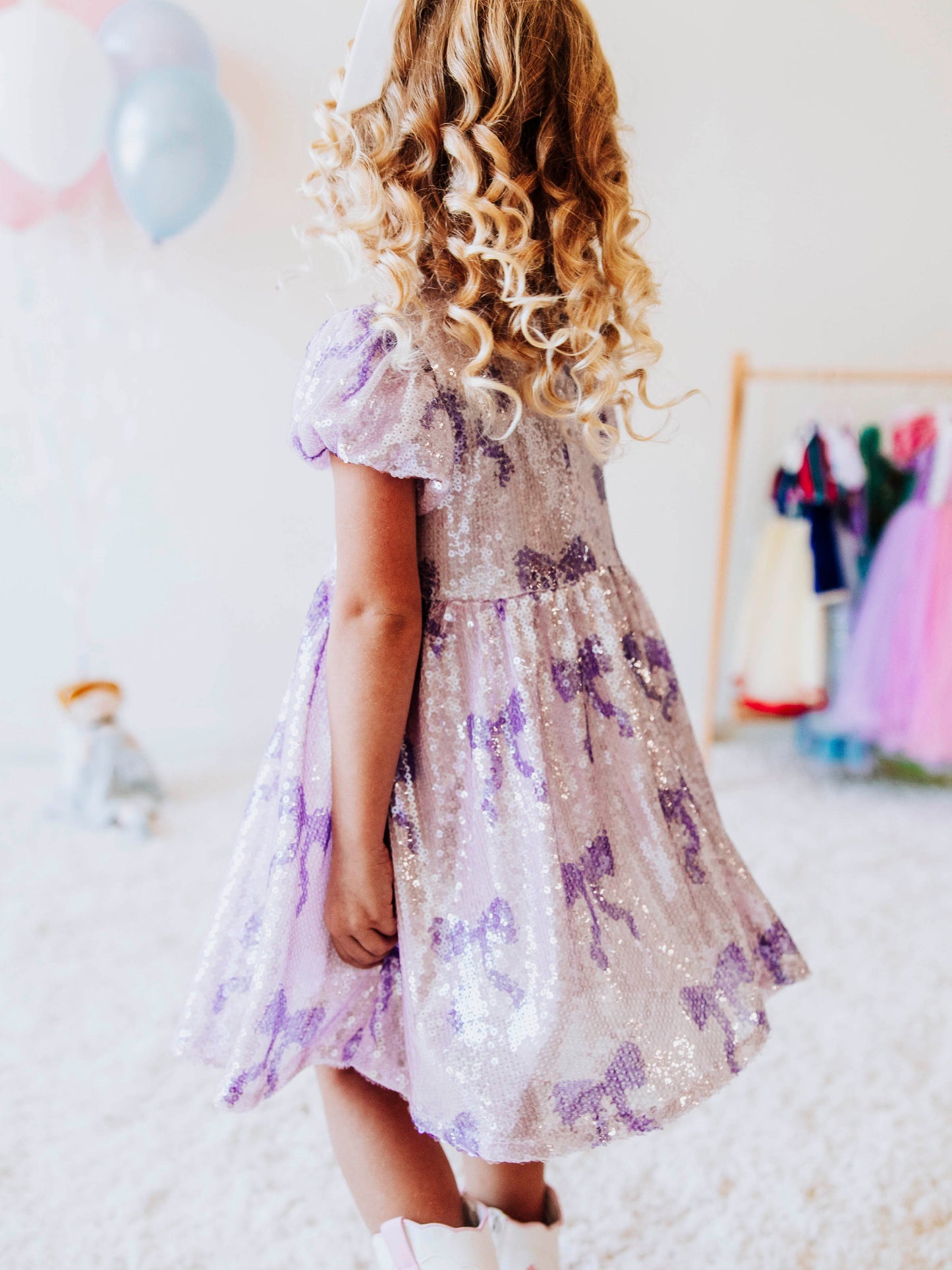 Let her sparkle and shine in our Lavender Sequin Bow Dress, a dazzling piece made for twirls, parties, and magical memories! Designed with shimmering lavender sequins and dainty bow details throughout, this girls’ sequin party dress captures the perfect mix of sweetness and sparkle.
The soft interior lining keeps her comfortable, while the puff sleeves and gathered skirt add a touch of classic charm. Perfect party dress, holiday dress and sparkle dress for any occasion! 