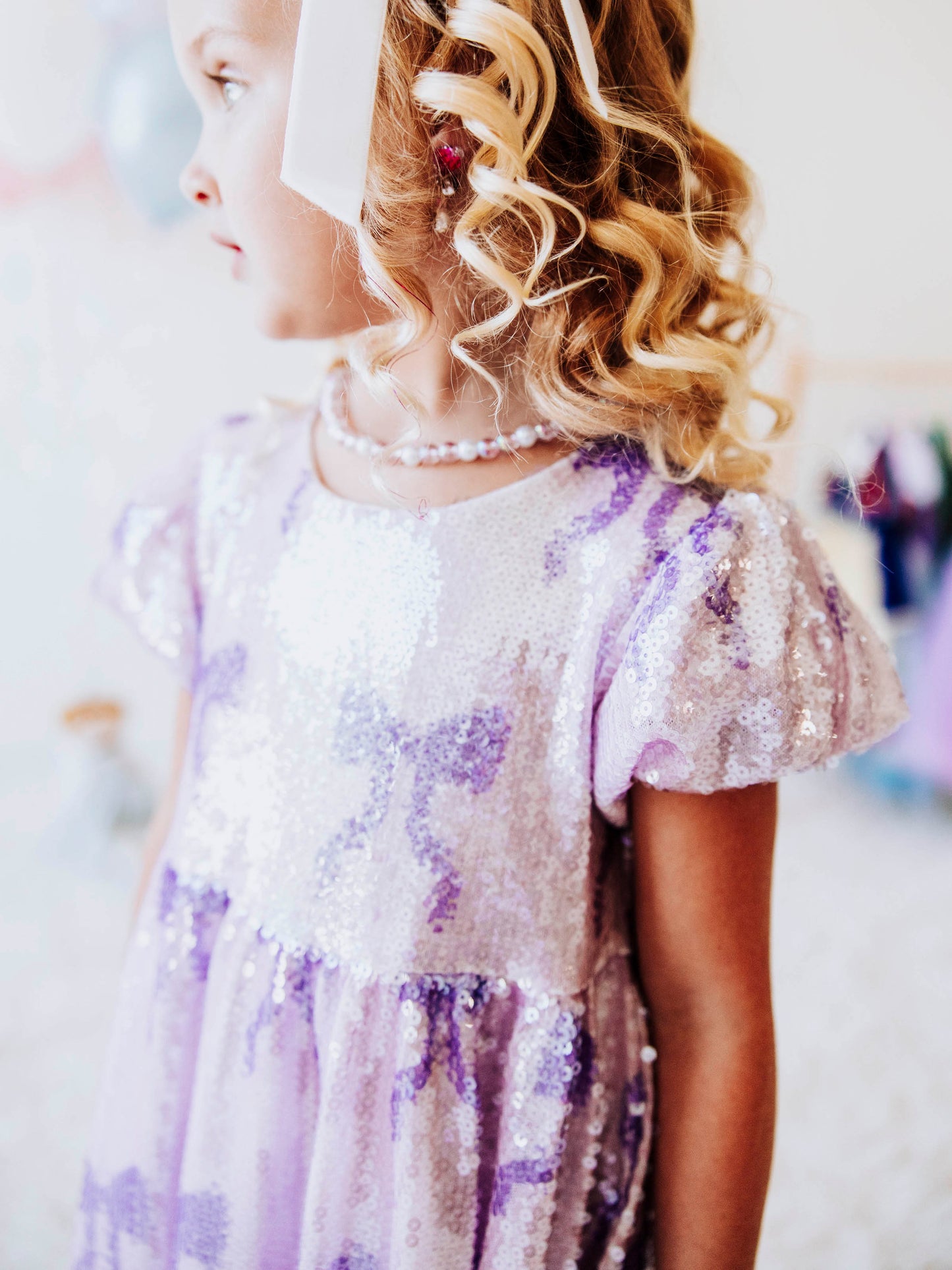 Let her sparkle and shine in our Lavender Sequin Bow Dress, a dazzling piece made for twirls, parties, and magical memories! Designed with shimmering lavender sequins and dainty bow details throughout, this girls’ sequin party dress captures the perfect mix of sweetness and sparkle.
The soft interior lining keeps her comfortable, while the puff sleeves and gathered skirt add a touch of classic charm. Perfect party dress, holiday dress and sparkle dress for any occasion! 