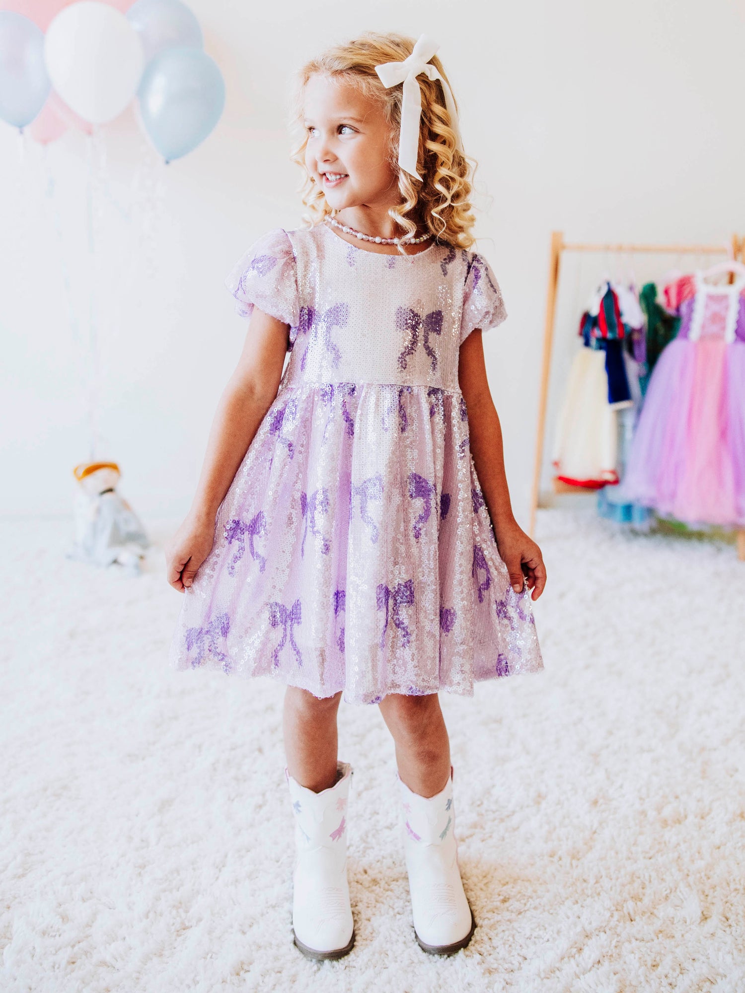 Let her sparkle and shine in our Lavender Sequin Bow Dress, a dazzling piece made for twirls, parties, and magical memories! Designed with shimmering lavender sequins and dainty bow details throughout, this girls’ sequin party dress captures the perfect mix of sweetness and sparkle.
The soft interior lining keeps her comfortable, while the puff sleeves and gathered skirt add a touch of classic charm. Perfect party dress, holiday dress and sparkle dress for any occasion! 