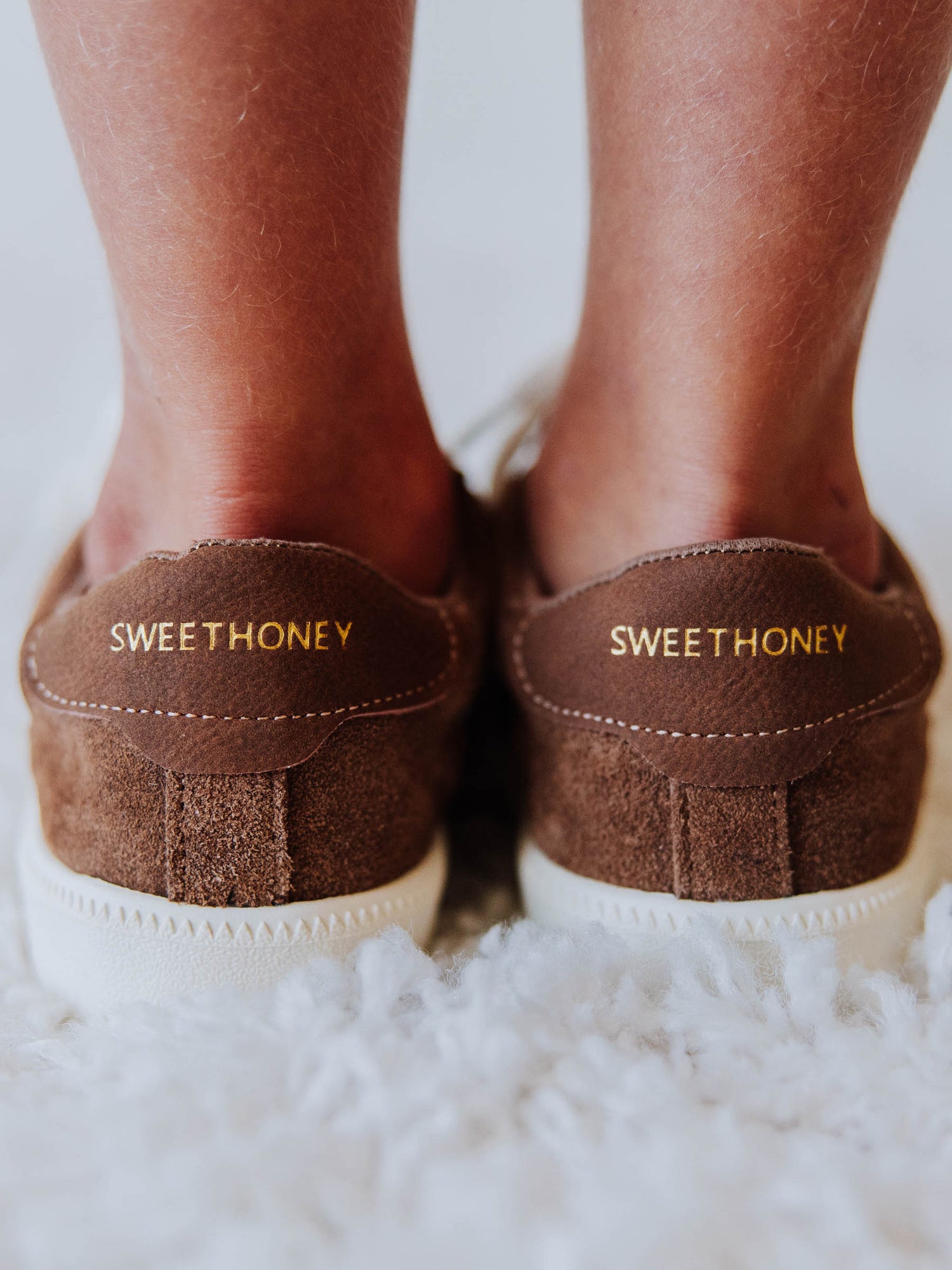 Brown mocha colored suede sneakers with SWEETHONEY stamped on the heel in gold.
