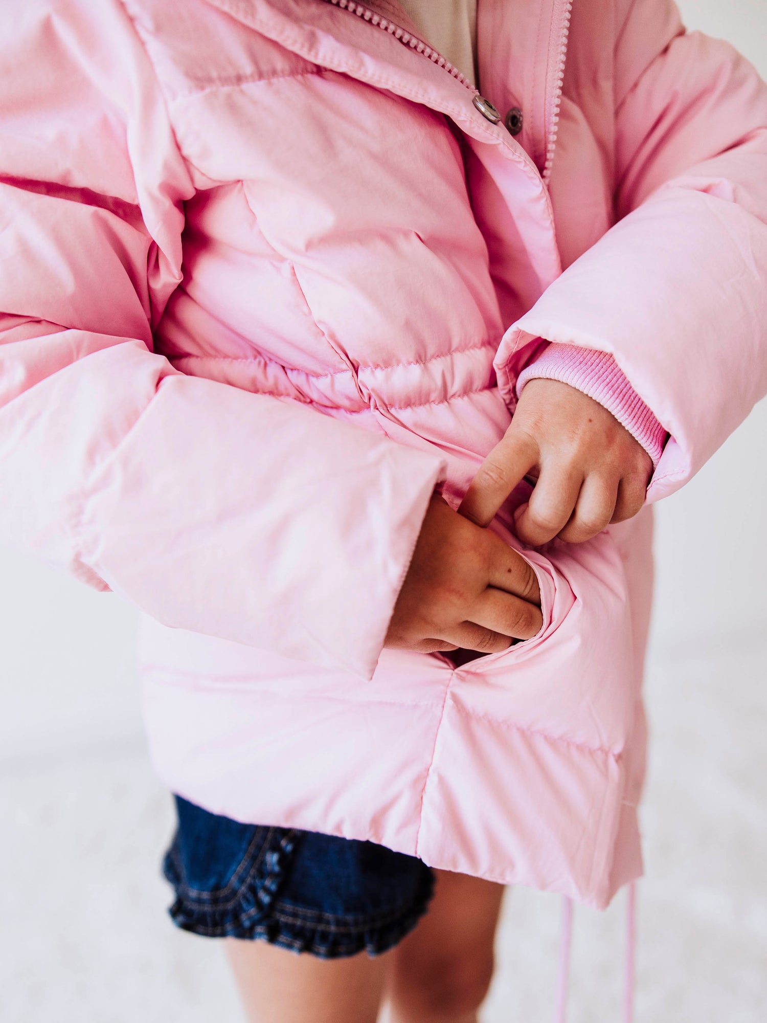 Keep her cozy and cute all season long in our Pink Puffer Jacket — the perfect blend of warmth and style! This soft, quilted jacket features a full zipper closure with a button placket, ensuring extra protection from chilly winds. Hidden front pockets keep little hands warm (or treasures tucked away), while the adjustable waist toggle allows for the perfect, comfortable fit. Designed in a beautiful blush pink hue, this girls’ puffer jacket pairs effortlessly with any winter outfit for a look that's fun!