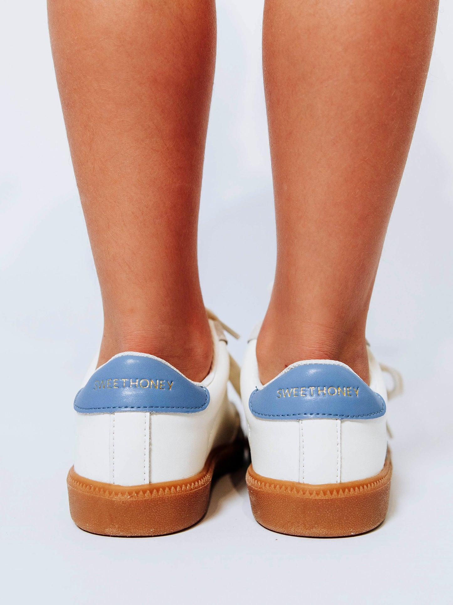 Fresh, fun, and full of SweetHoney style — our Signature Sneakers in dusty blue and white are the perfect mix of comfort and charm! Featuring our bold “SH” SweetHoney logo, soft suede accents, and durable gum soles, these boutique kids’ sneakers are designed for everyday adventures. Whether paired with twirl dresses or playtime outfits, they’re the ultimate blend of fashion and function for little trendsetters on the go.
