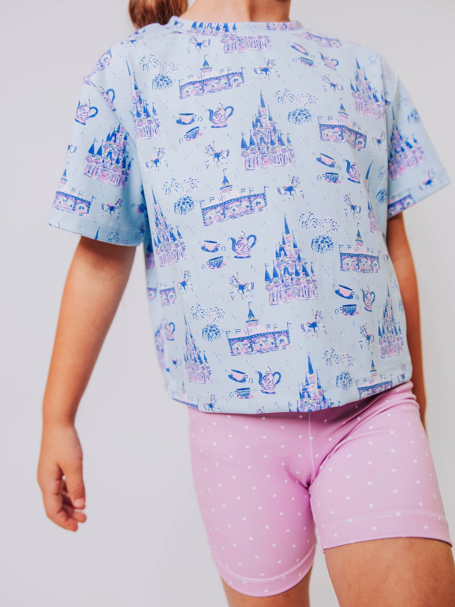 Serve up style and fun with our girls’ “Most Magical” active set, designed for comfort, movement, and everyday play. This adorable sleeveless dress features a whimsical print inspired by magical castles, carousels, and fairy-tale adventures — perfect for little dreamers who love both sports and sparkle. The lightweight, stretchy performance fabric keeps her cool and comfortable from the court to the playground, while the flowy shirt design and active shorts allows for easy twirls and active fun.