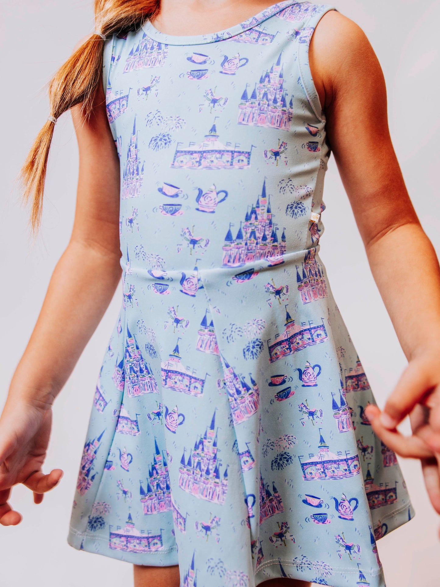 Serve up style and fun with our girls’ “Most Magical” tennis dress, designed for comfort, movement, and everyday play. This adorable sleeveless dress features a whimsical print inspired by magical castles, carousels, and fairy-tale adventures — perfect for little dreamers who love both sports and sparkle. The lightweight, stretchy performance fabric keeps her cool and comfortable from the court to the playground, while the flared skirt design allows for easy twirls and active fun.
