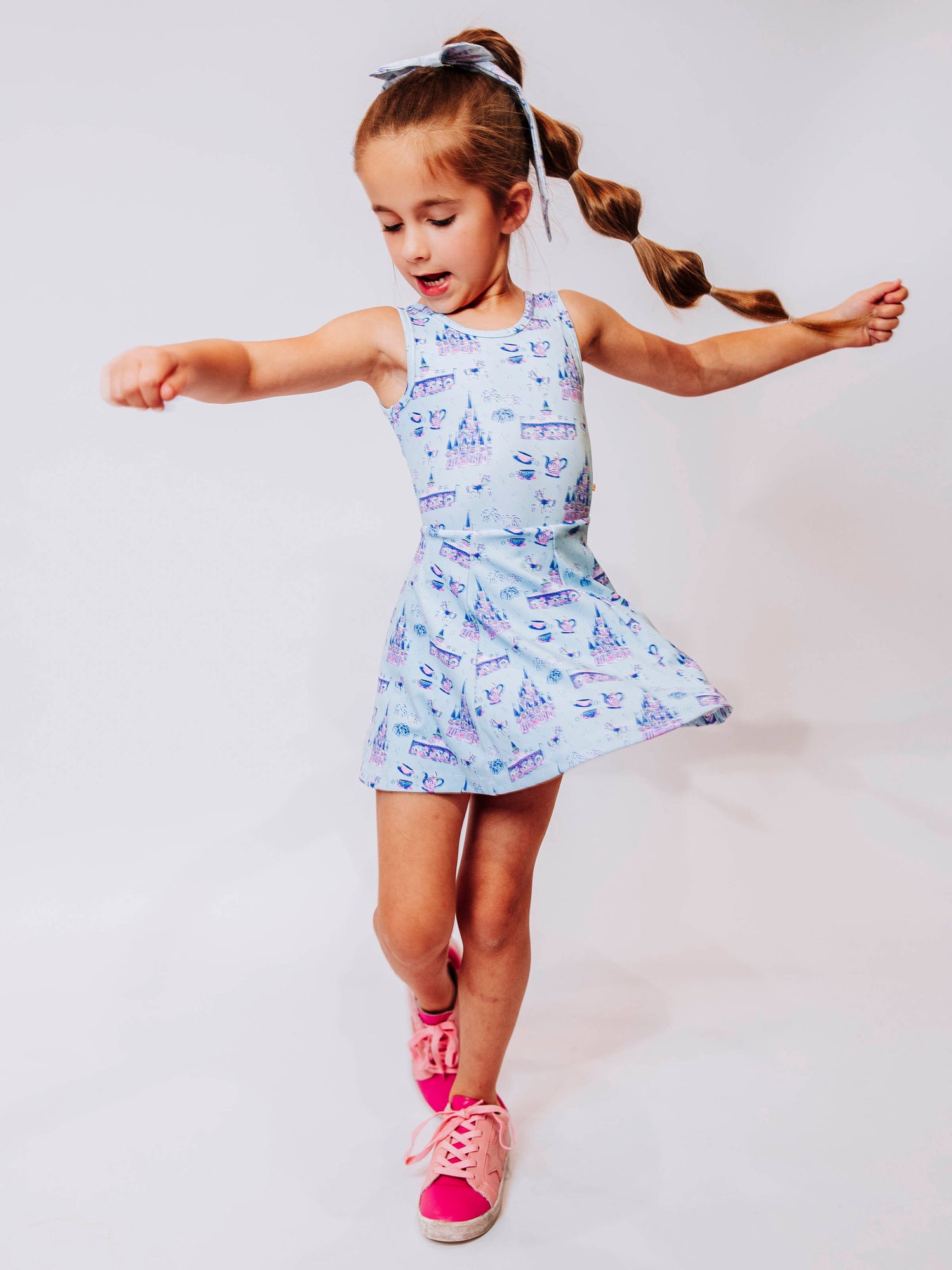 Serve up style and fun with our girls’ “Most Magical” tennis dress, designed for comfort, movement, and everyday play. This adorable sleeveless dress features a whimsical print inspired by magical castles, carousels, and fairy-tale adventures — perfect for little dreamers who love both sports and sparkle. The lightweight, stretchy performance fabric keeps her cool and comfortable from the court to the playground, while the flared skirt design allows for easy twirls and active fun.