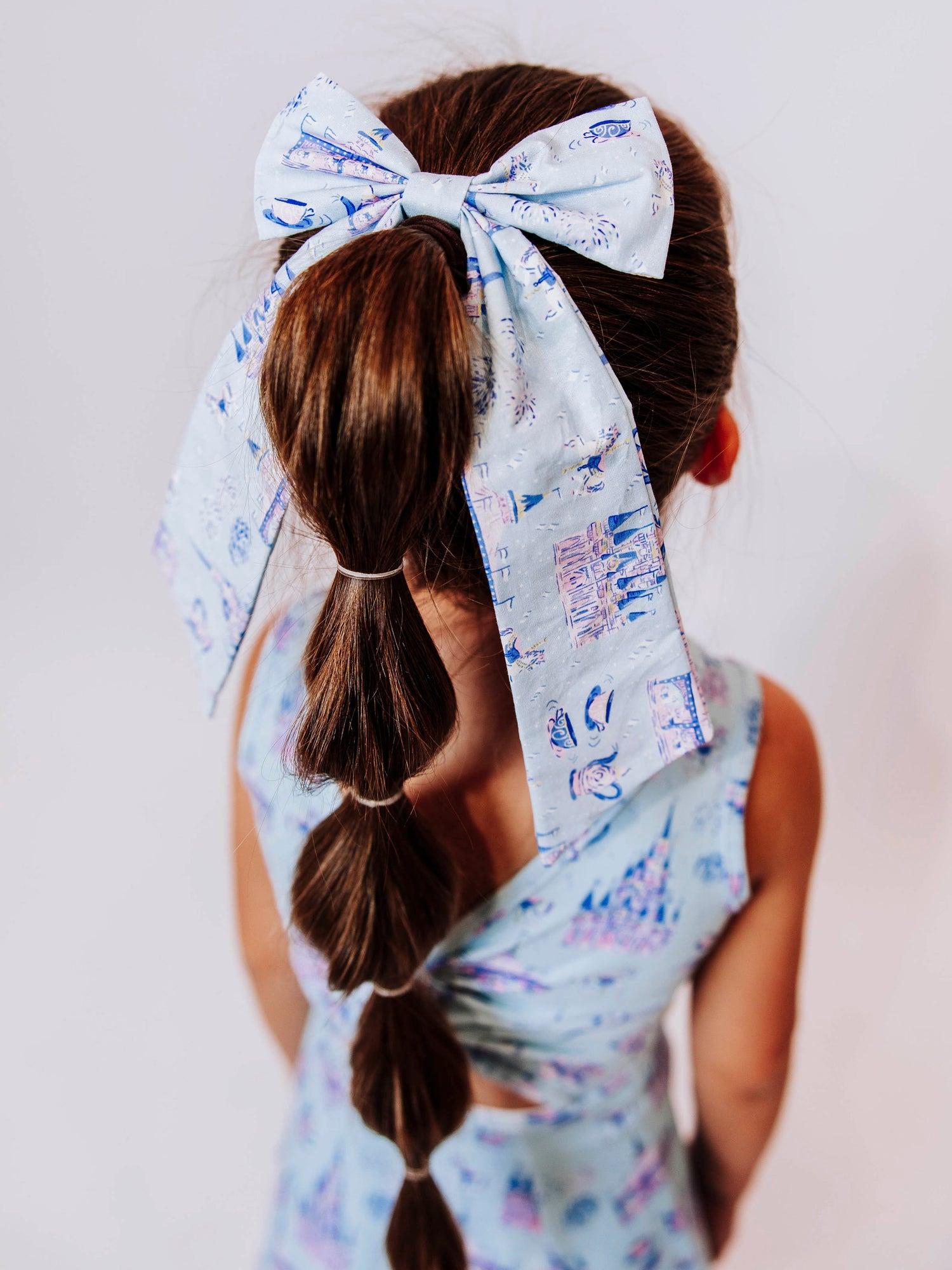 Add a touch of fairytale sparkle to any outfit with our Most Magical Long Tail Bow! This enchanting hair accessory features our signature Most Magical print — filled with dreamy castles, teacups, and fireworks in soft pastel hues. Made from smooth, lightweight fabric with flowing tails, it ties perfectly for picture days, park days, or magical adventures. A must-have finishing touch for your little princess!
