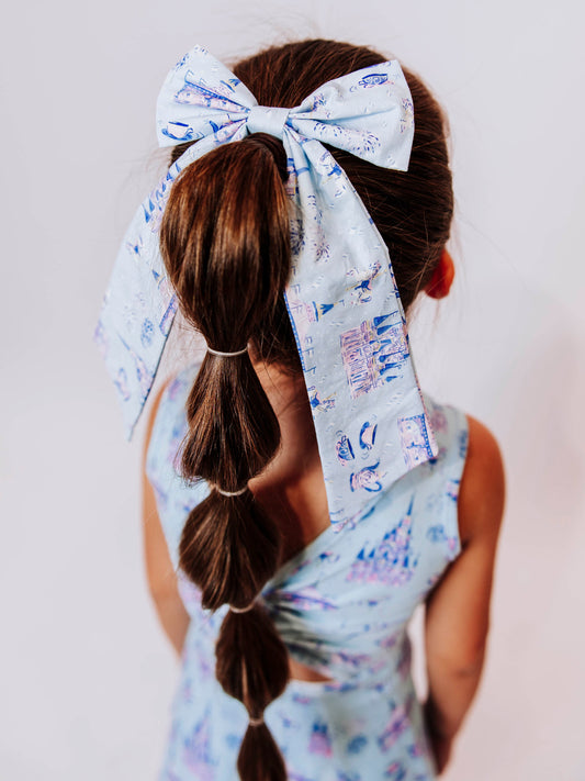 Add a touch of fairytale sparkle to any outfit with our Most Magical Long Tail Bow! This enchanting hair accessory features our signature Most Magical print — filled with dreamy castles, teacups, and fireworks in soft pastel hues. Made from smooth, lightweight fabric with flowing tails, it ties perfectly for picture days, park days, or magical adventures. A must-have finishing touch for your little princess!