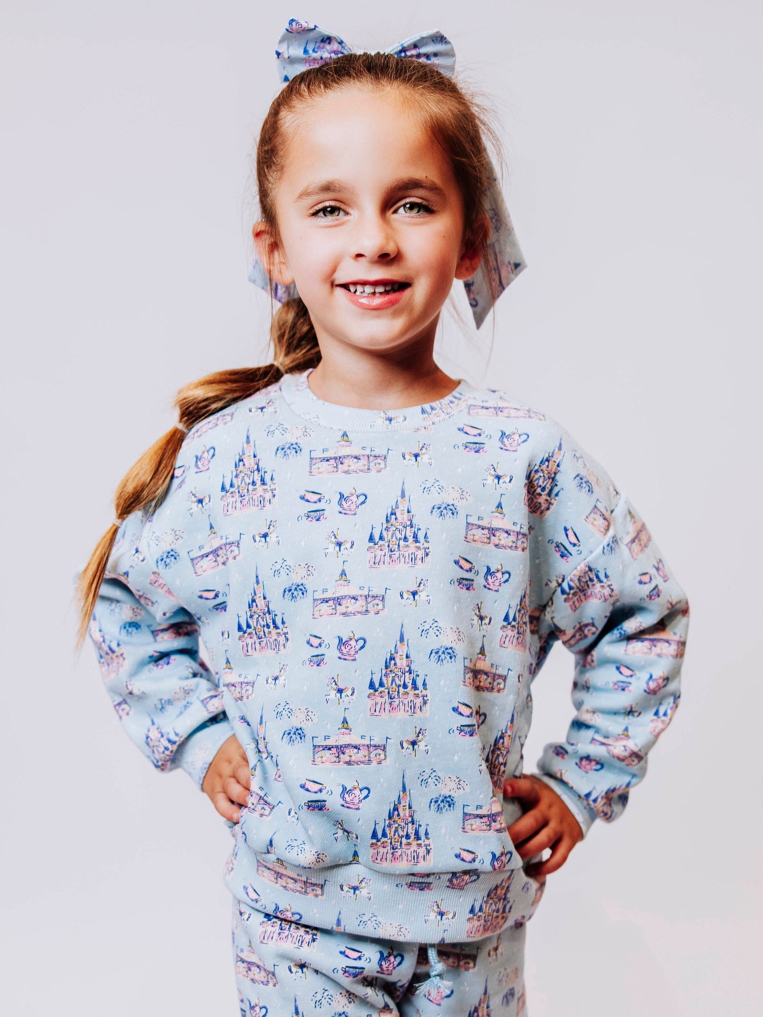 Cozy up in enchanted style with our Most Magical Sweat Set! Featuring a dreamy print of castles, teacups, and fireworks on a soft pastel background, this girls’ sweat set brings all the comfort and charm of your favorite fairytale. Made from ultra-soft fabric with a relaxed fit, the sweatshirt and jogger pants are perfect for playtime, travel days, or snuggling up at home. Magical comfort meets everyday wear!