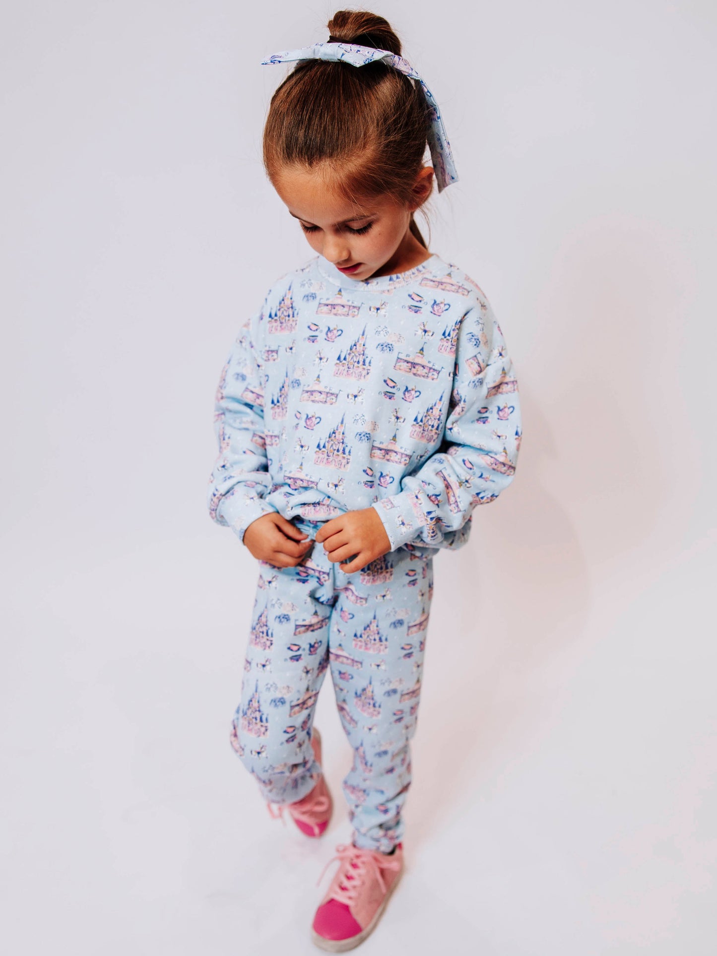 Cozy up in enchanted style with our Most Magical Sweat Set! Featuring a dreamy print of castles, teacups, and fireworks on a soft pastel background, this girls’ sweat set brings all the comfort and charm of your favorite fairytale. Made from ultra-soft fabric with a relaxed fit, the sweatshirt and jogger pants are perfect for playtime, travel days, or snuggling up at home. Magical comfort meets everyday wear!
