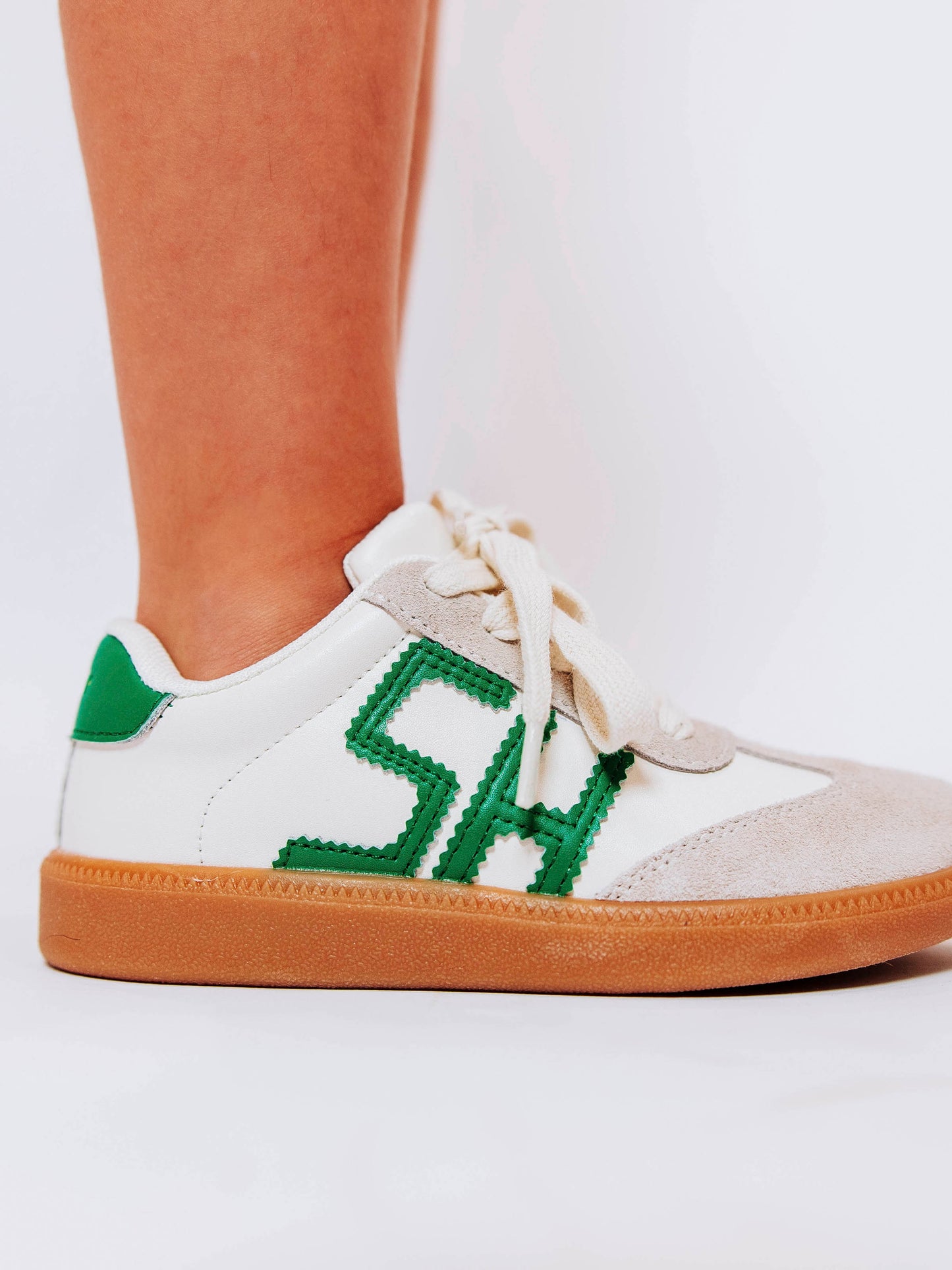 Fresh, fun, and full of SweetHoney style — our Signature Sneakers in green and white are the perfect mix of comfort and charm! Featuring our bold “SH” SweetHoney logo, soft suede accents, and durable gum soles, these boutique kids’ sneakers are designed for everyday adventures. Whether paired with twirl dresses or playtime outfits, they’re the ultimate blend of fashion and function for little trendsetters on the go.