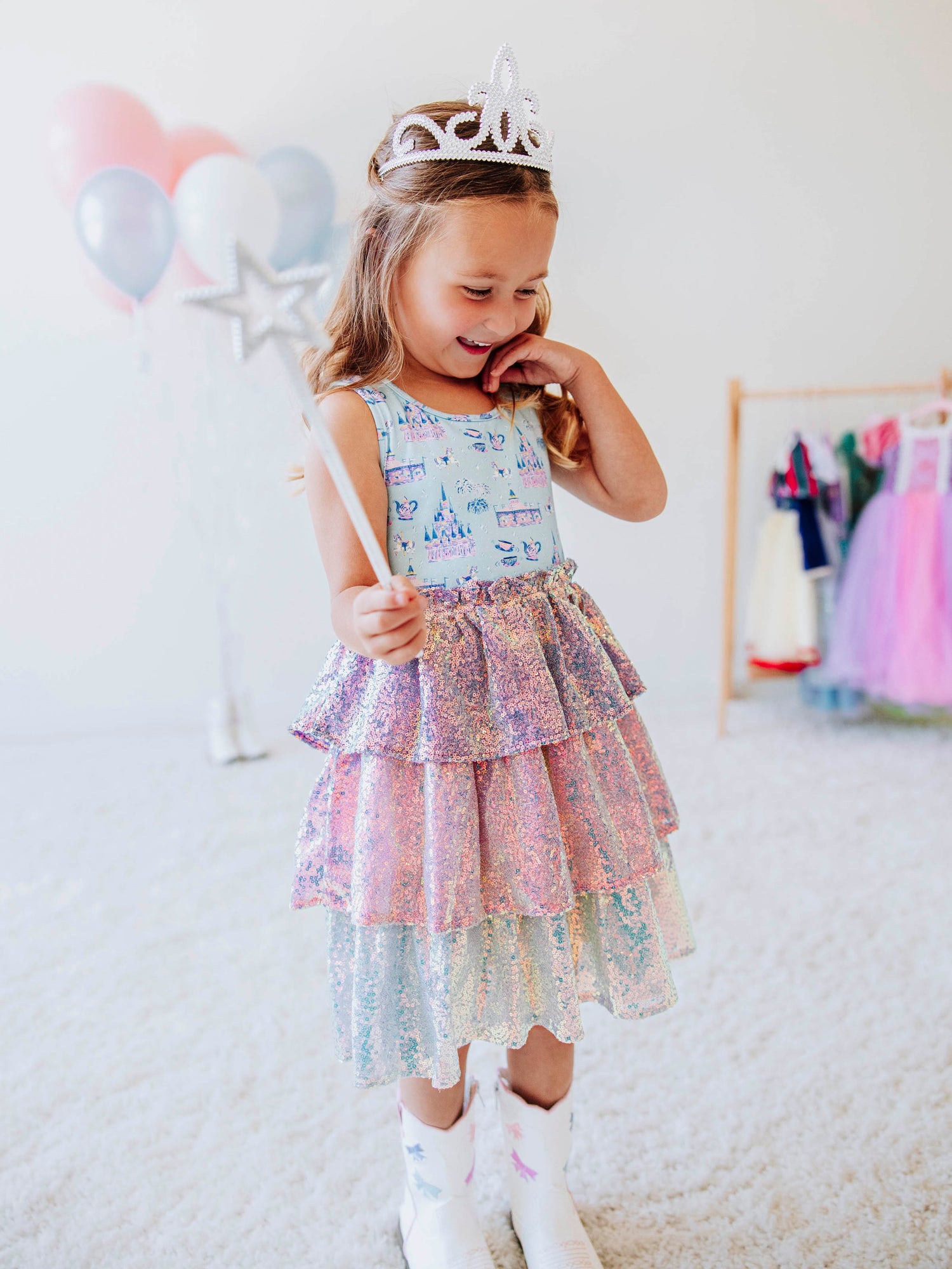 Make every day feel like a fairytale in our Most Magical Tiered Sparkle Dress! This enchanting girls’ dress features our signature “Most Magical” print bodice — filled with dreamy castles, carousels, and whimsical details — paired with a tiered iridescent sequin skirt that shimmers with every twirl. Designed for comfort and style, it’s perfect for holiday photos, birthday parties, or any moment that calls for a little extra sparkle. 