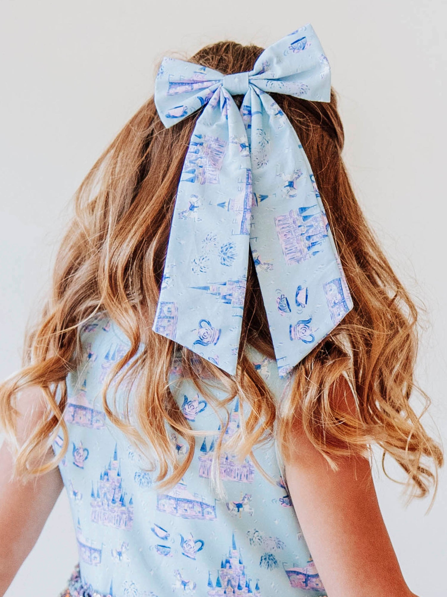 Add a touch of fairytale sparkle to any outfit with our Most Magical Long Tail Bow! This enchanting hair accessory features our signature Most Magical print — filled with dreamy castles, teacups, and fireworks in soft pastel hues. Made from smooth, lightweight fabric with flowing tails, it ties perfectly for picture days, park days, or magical adventures. A must-have finishing touch for your little princess!