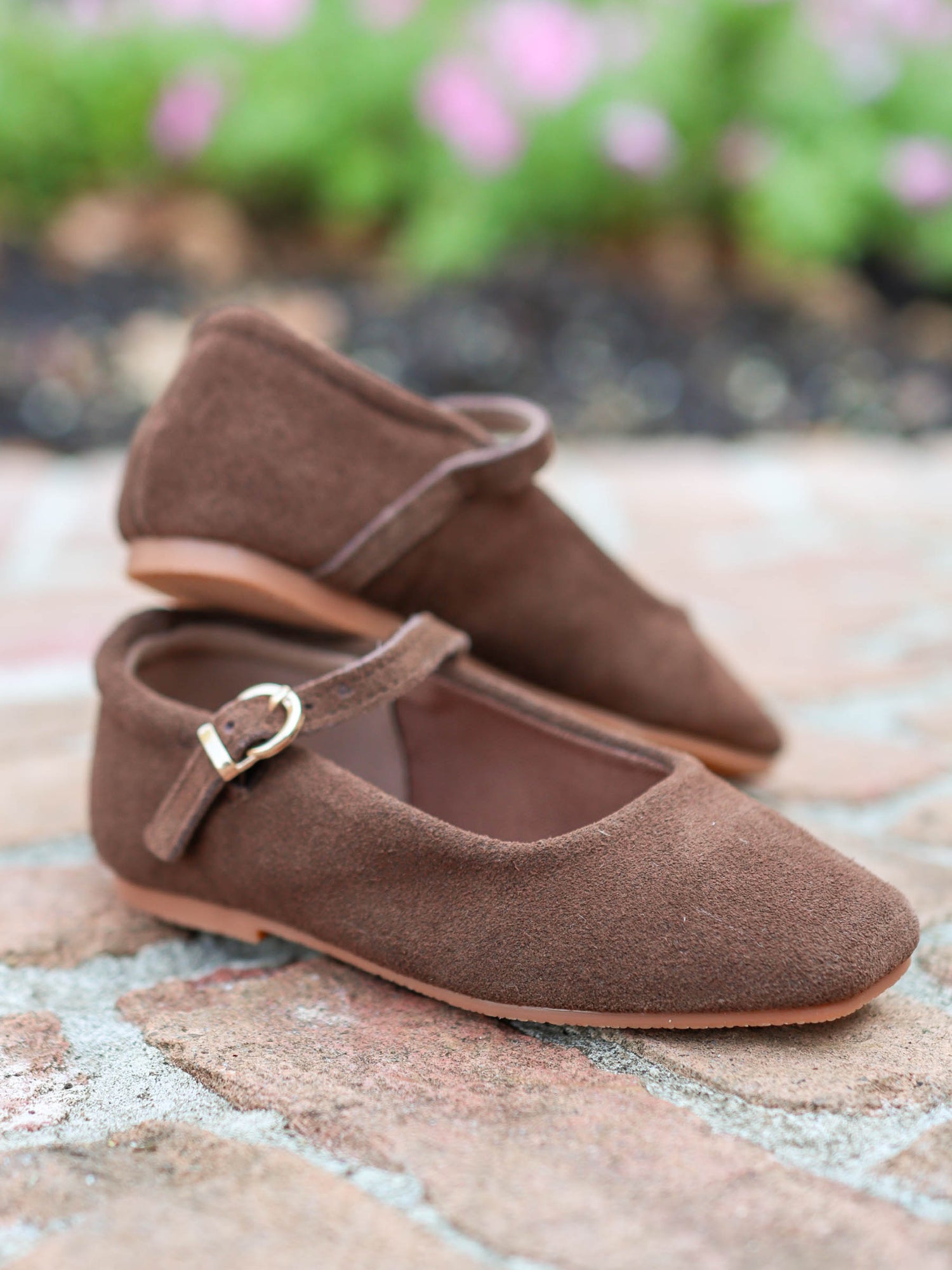 A rich brown square toe ballet style Mary Jane with functional metal clasp and rubber soles. 