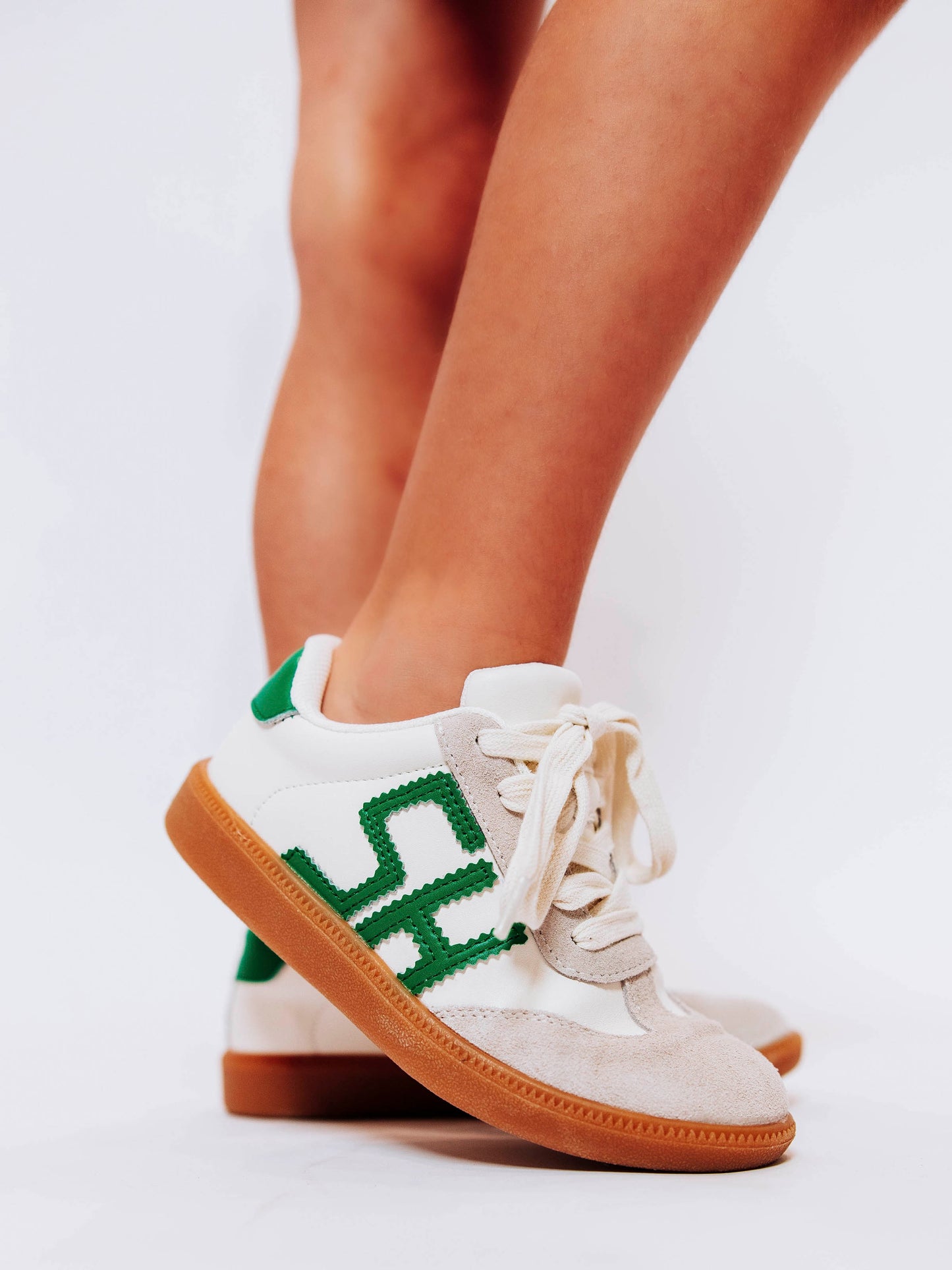 Fresh, fun, and full of SweetHoney style — our Signature Sneakers in green and white are the perfect mix of comfort and charm! Featuring our bold “SH” SweetHoney logo, soft suede accents, and durable gum soles, these boutique kids’ sneakers are designed for everyday adventures. Whether paired with twirl dresses or playtime outfits, they’re the ultimate blend of fashion and function for little trendsetters on the go.