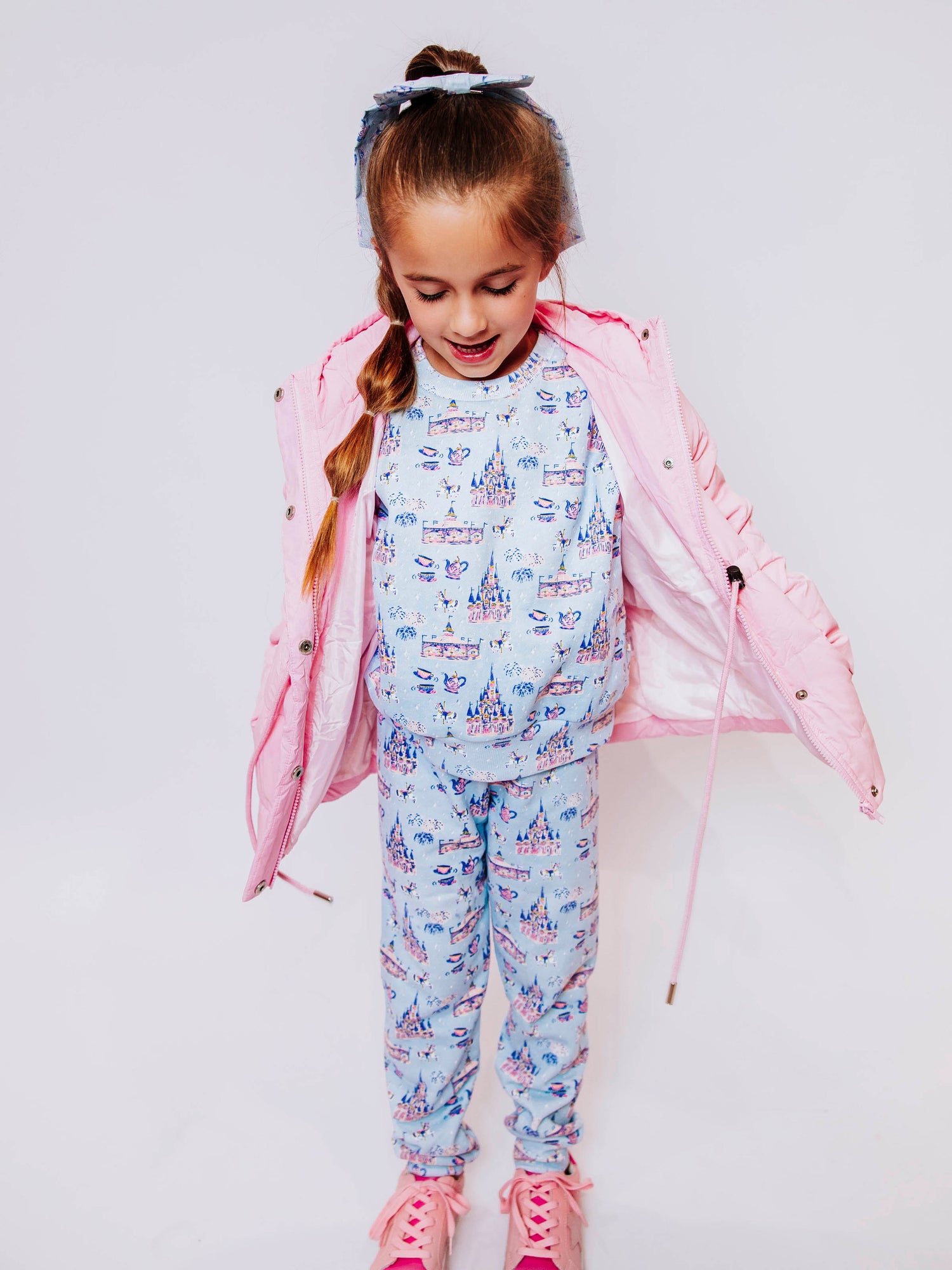 Keep her cozy and cute all season long in our Pink Puffer Jacket — the perfect blend of warmth and style! This soft, quilted jacket features a full zipper closure with a button placket, ensuring extra protection from chilly winds. Hidden front pockets keep little hands warm (or treasures tucked away), while the adjustable waist toggle allows for the perfect, comfortable fit. Designed in a beautiful blush pink hue, this girls’ puffer jacket pairs effortlessly with any winter outfit for a look that's fun!