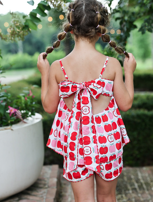 Backside of girl outside in two piece apple set with bow