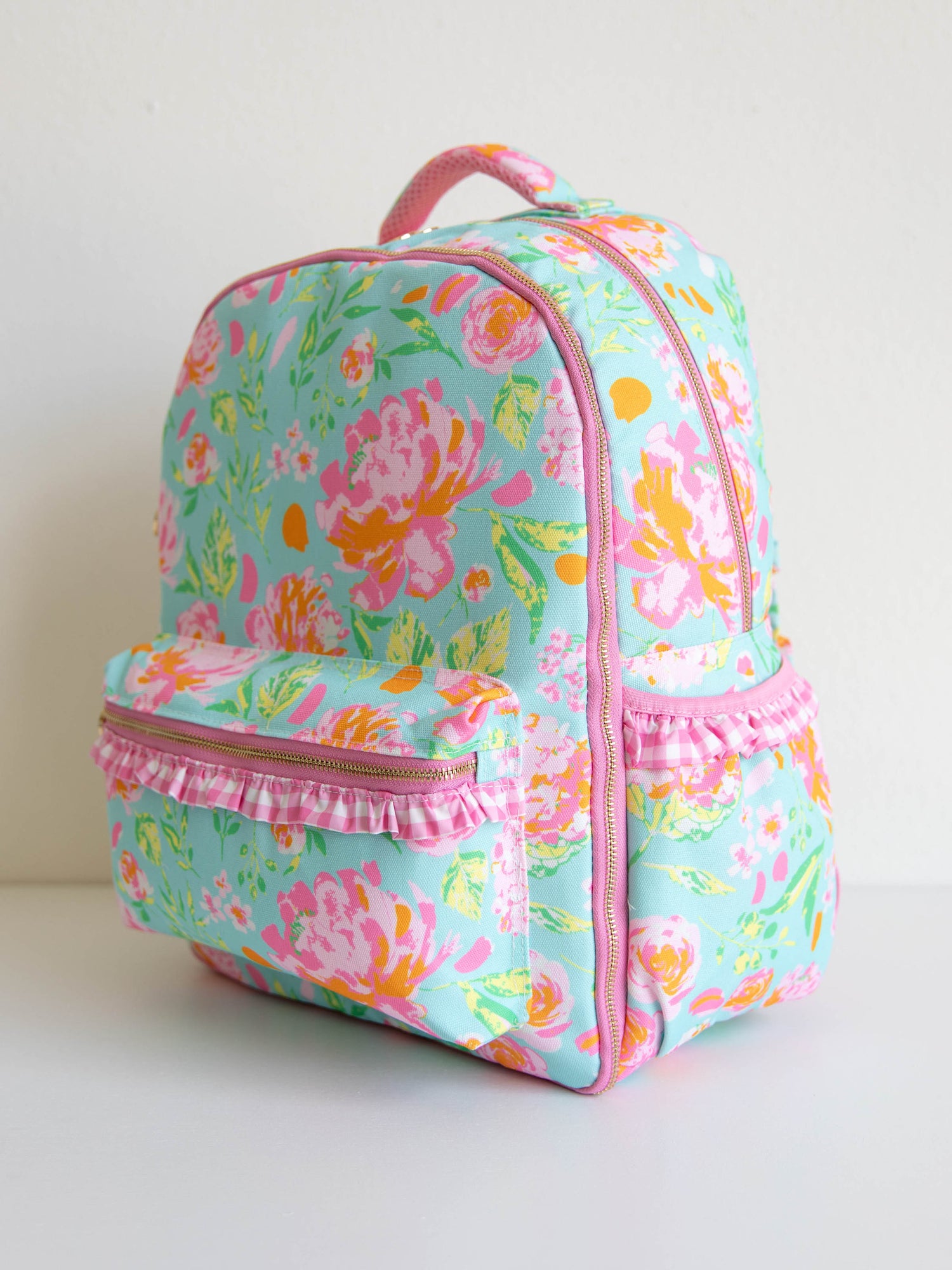 colorful and floral backpack with zippers, ruffles and front pocket