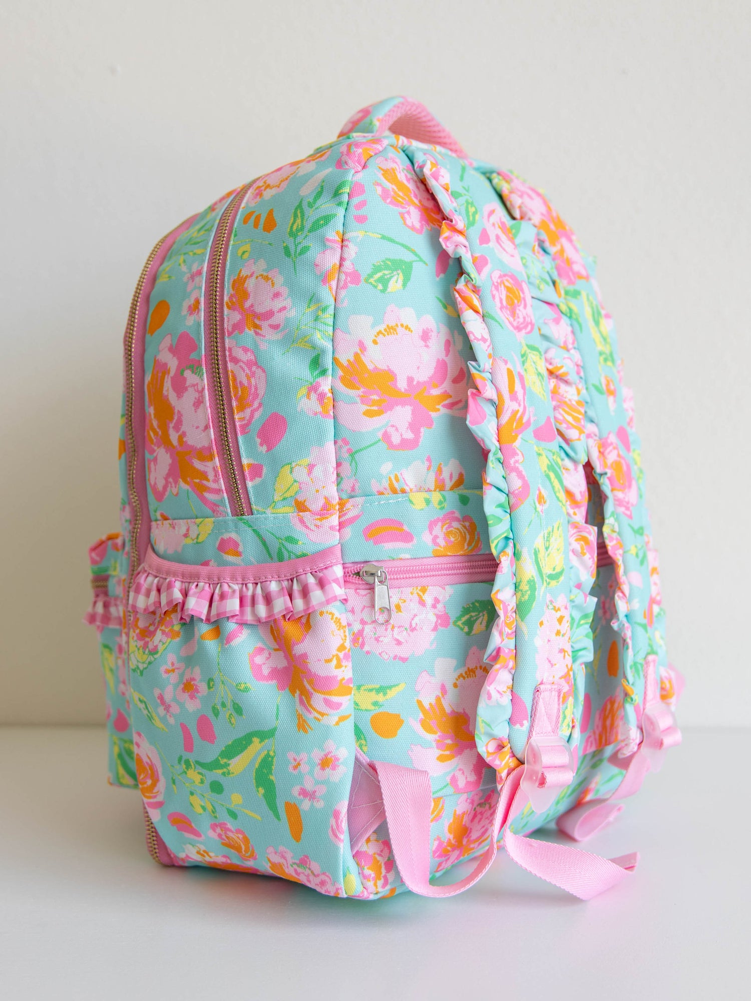 colorful and floral backpack with zippers, ruffles and front pocket