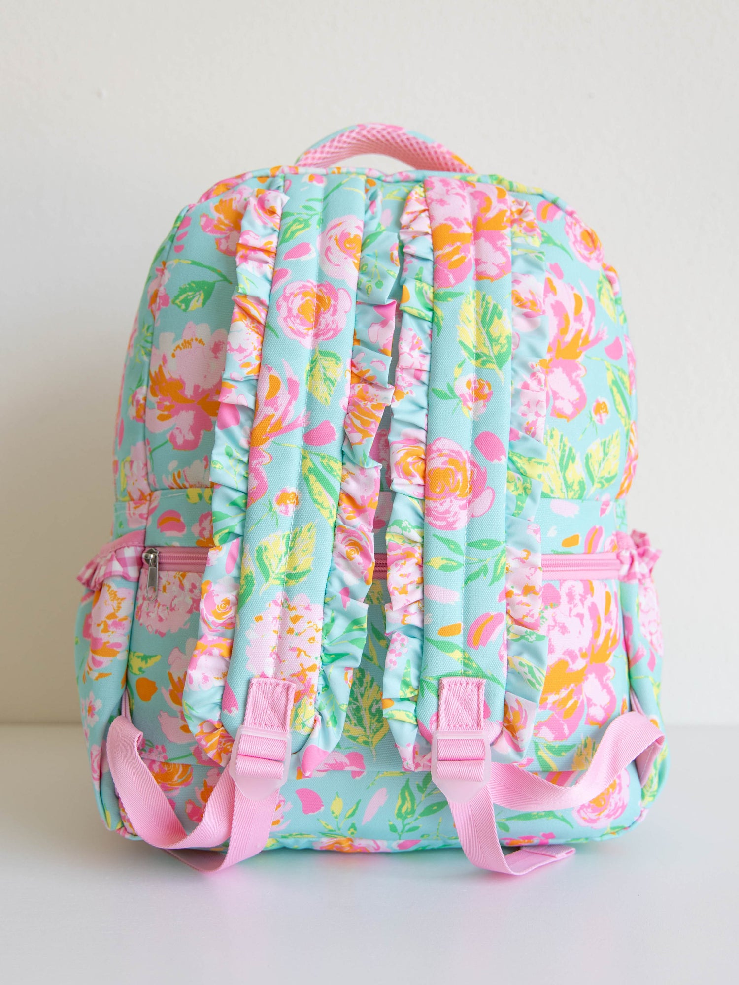 colorful and floral backpack with zippers, ruffles and front pocket